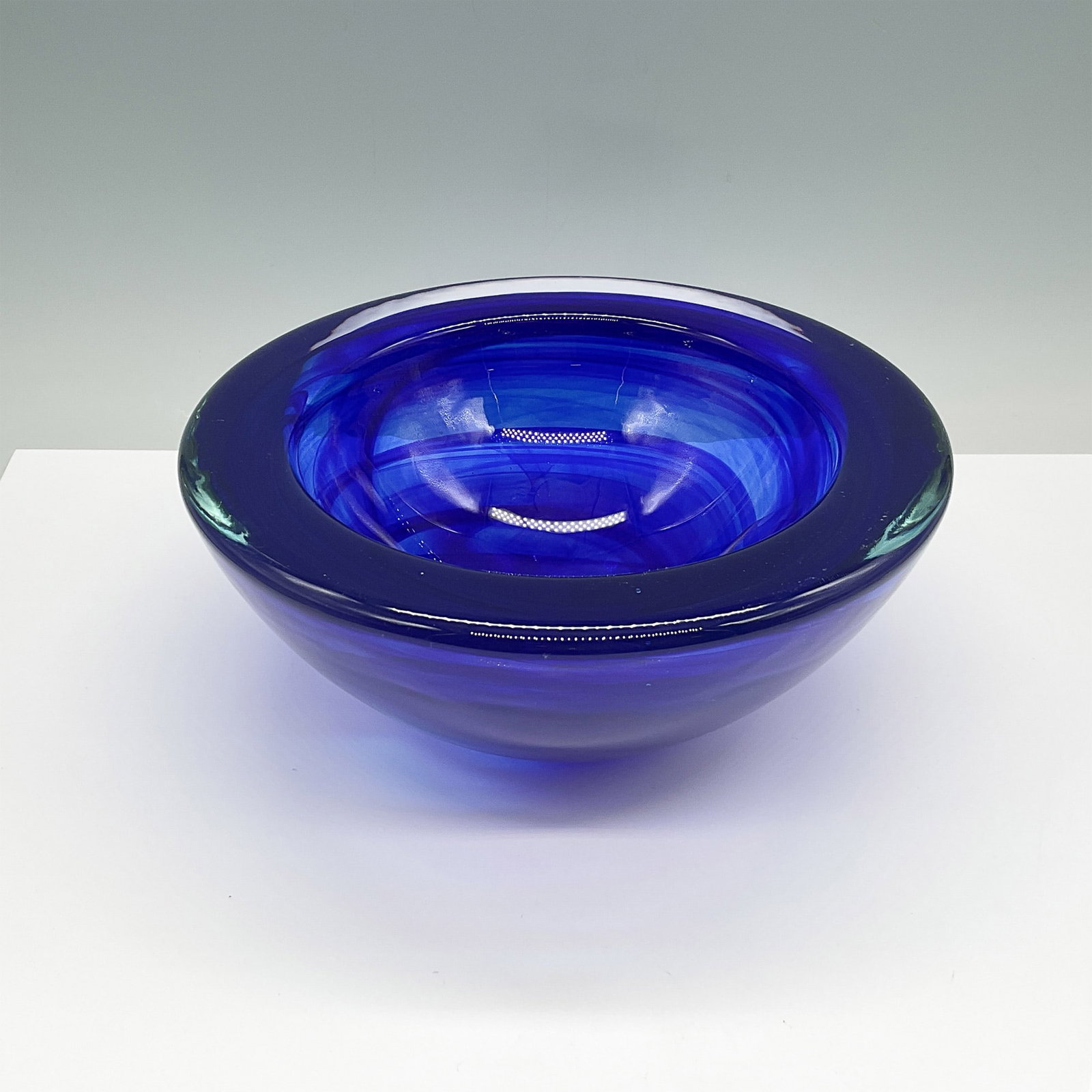 Kosta Boda Blue Art Glass Bowl: Stunning Kosta Boda blue art glass bowl with a vibrant cobalt hue and a smooth, polished finish. This piece exemplifies the renowned Swedish craftsmanship of Kosta Boda, known for its innovative and a