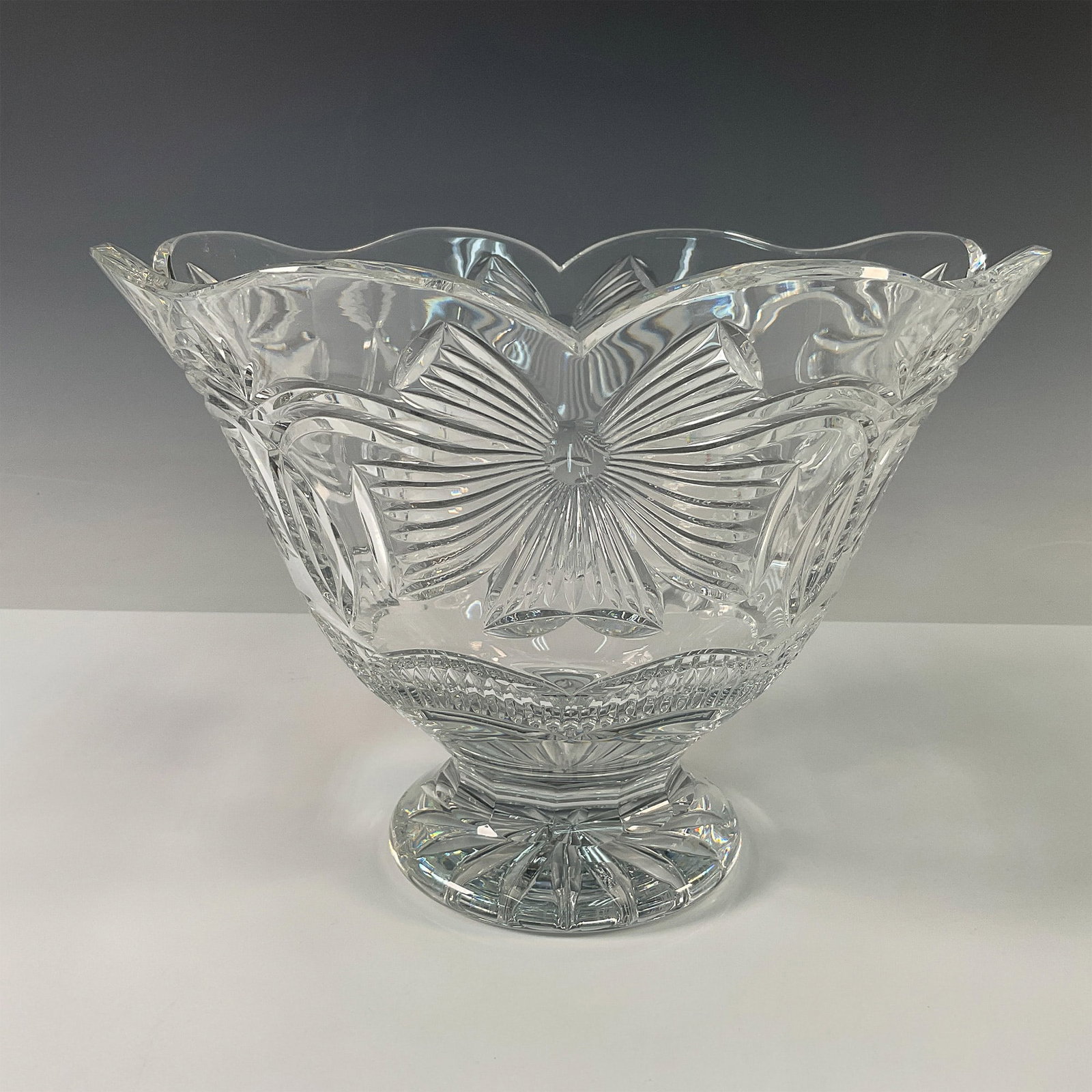Waterford Crystal Centerpiece, Holiday Ribbons: This exquisite limited edition Waterford crystal centerpiece is crafted in the elegant Holiday Ribbons pattern, showcasing intricate cuts and a timeless design. Featuring a flared scalloped rim and a 