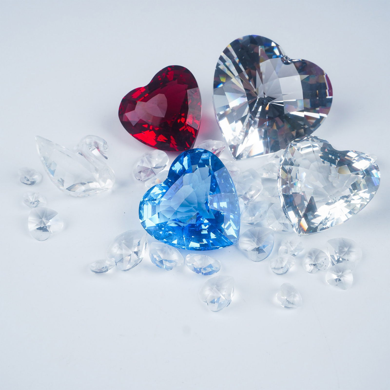 Swarovski Crystal Figures and Decorative Objects Assortment: This charming Swarovski crystal collection features six exquisite decorative objects, including a clear crystal faceted heart, measuring approximately 2.5 inches in height, housed in its original box.