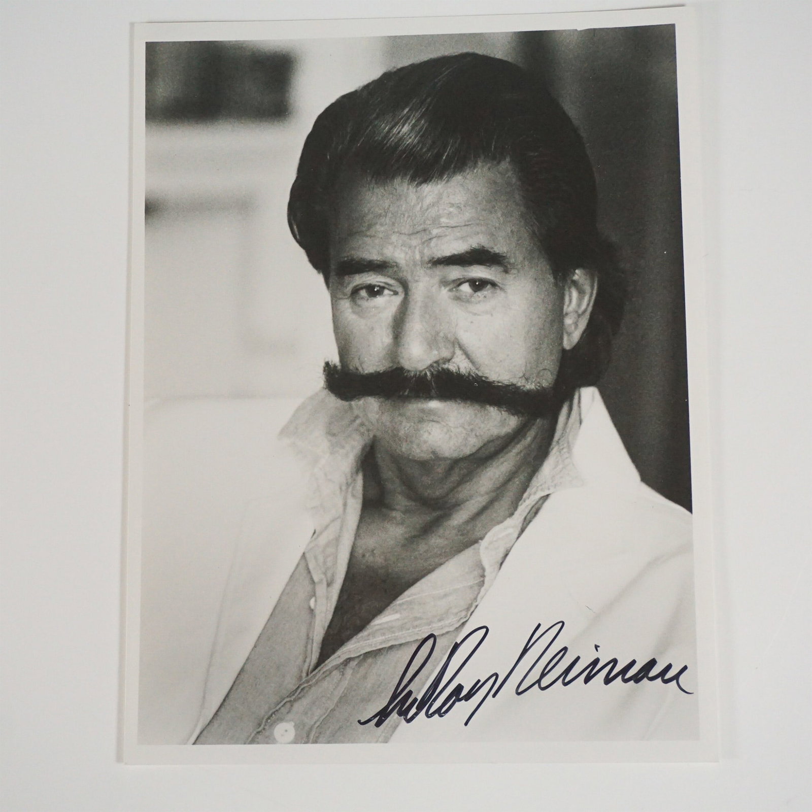 Leroy Neiman Autographed Photograph: A black and white autographed photograph of Leroy Neiman (1921-2012), the celebrated American artist known for his vibrant, impressionistic depictions of sporting events, entertainment figures, and hi