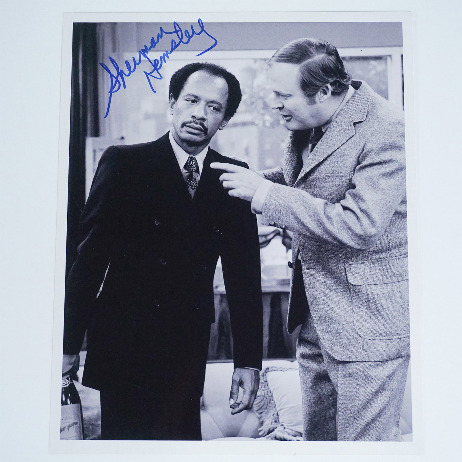 Sherman Hemsley Signed Photograph with COA: Black and white 8 x 10-inch photograph featuring Sherman Hemsley, known for his iconic role as George Jefferson in The Jeffersons, engaged in a scene with another actor. The photograph is personally s