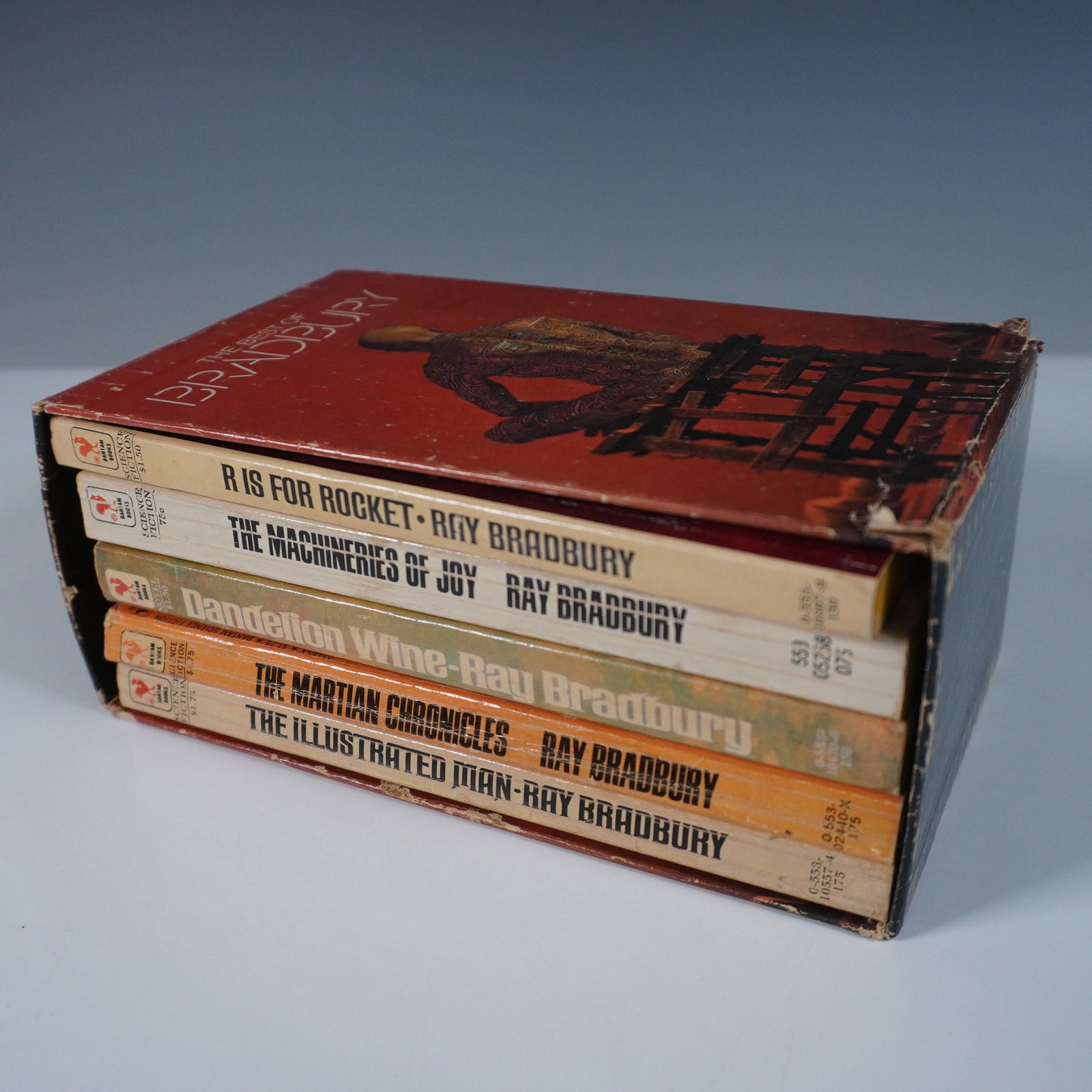 5pc Ray Bradbury Vintage Paperback Book Set, Signed: This lot features a vintage 5-piece set of paperback books by the acclaimed science fiction and fantasy writer Ray Bradbury, housed in its original slipcase. The set includes R is for Rocket, The Mach