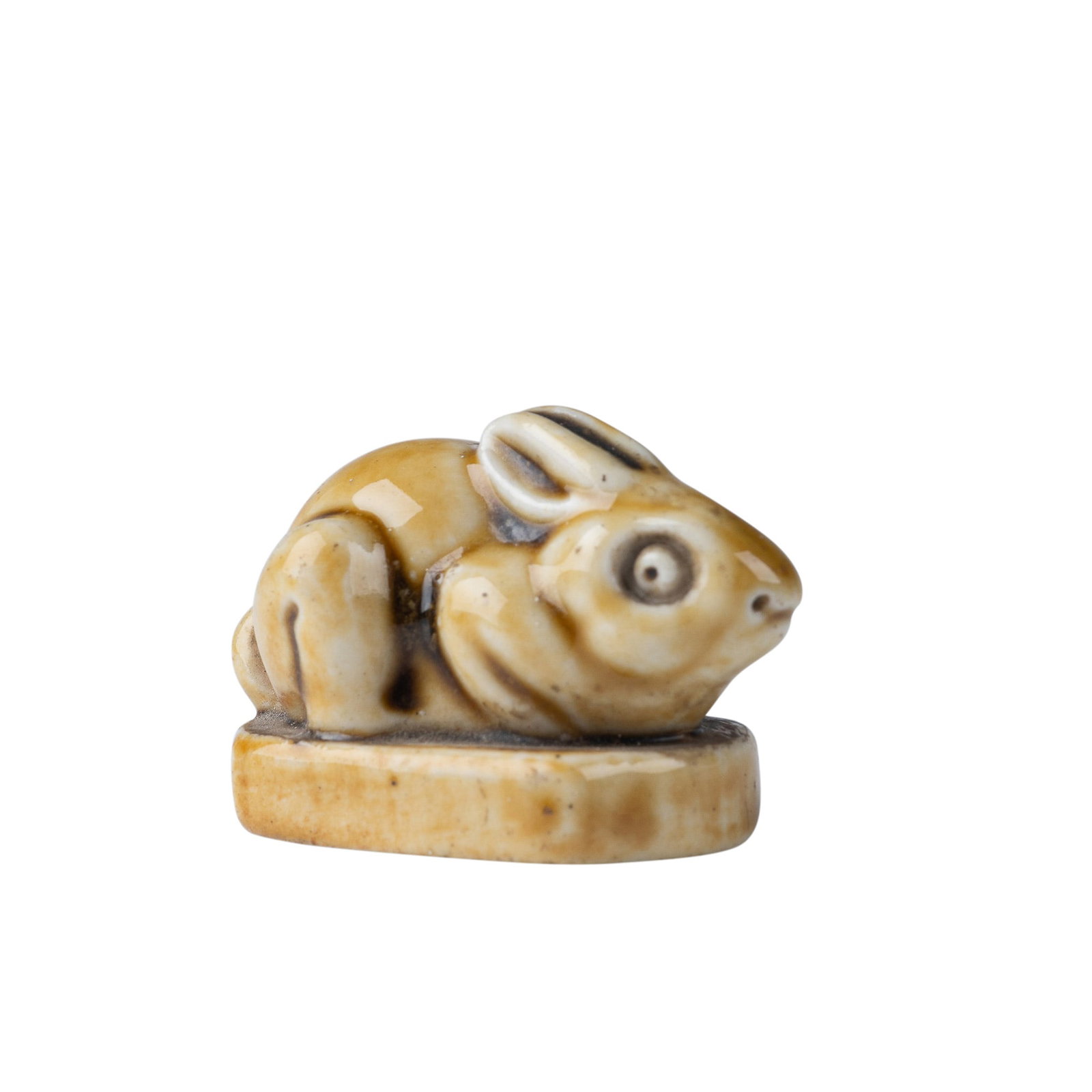 Royal Doulton Light Brown Stoneware Mark Marshall Rabbit: A delightful Royal Doulton stoneware figurine of a bunny, designed by the esteemed artist Mark V. Marshall. This charming piece is finished in a warm light brown glaze with soft tonal variations, high
