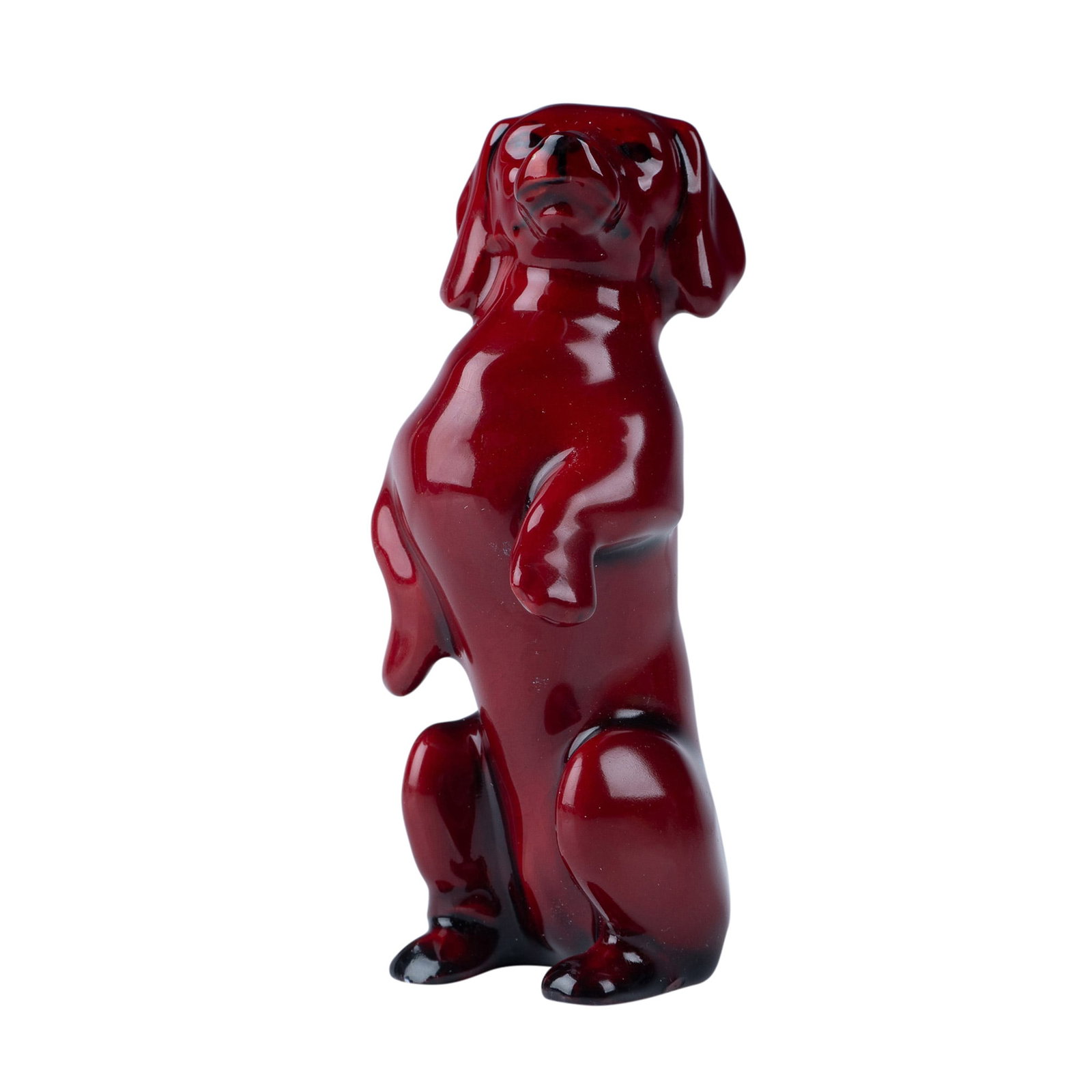 Royal Doulton Flambe Figurine, Begging Dachshund: A charming Royal Doulton Flambe porcelain figurine depicting a dachshund in a begging pose. This piece showcases the signature deep red and black glaze of Doulton's Flambe line, creating a striking vi