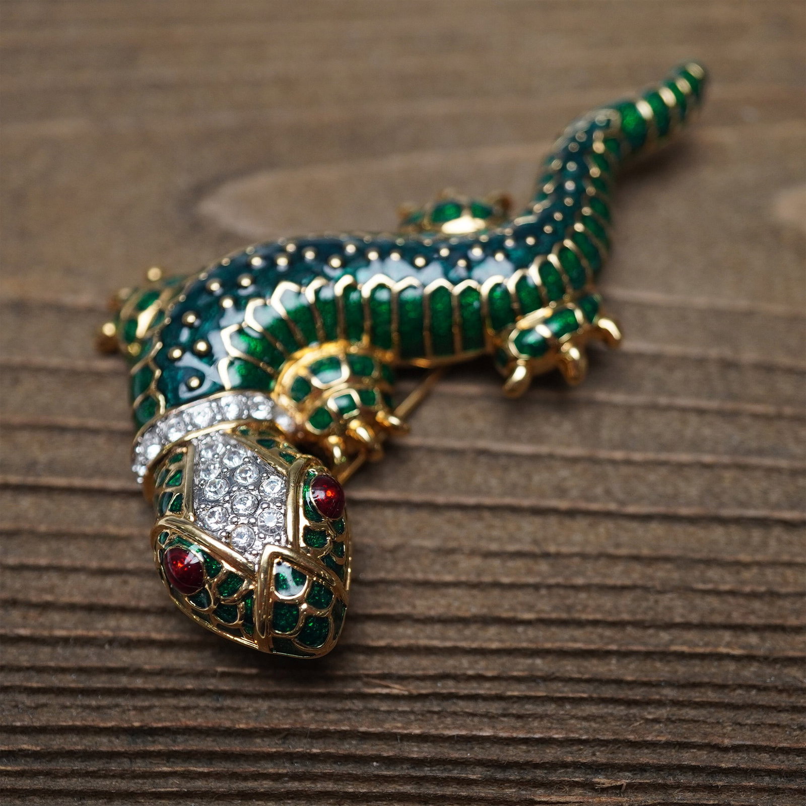 KJL Kenneth Jay Lane Enameled Lizard Brooch Pin: This striking Kenneth Jay Lane (KJL) enameled lizard brooch showcases the designer?s signature bold and whimsical style. The piece features green and black enamel detailing, accented with pave-set cle