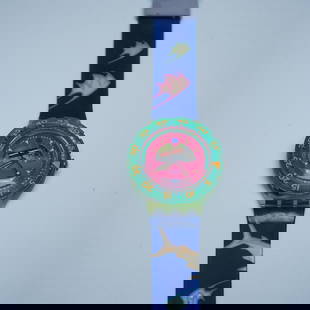 Swatch Scuba 200 Watch, Tropical Fish Design: A vibrant Swatch Scuba 200 watch featuring a tropical fish-themed design with a blue strap adorned with colorful fish graphics, a green translucent case, and a pink dial with a rotating bezel marked i
