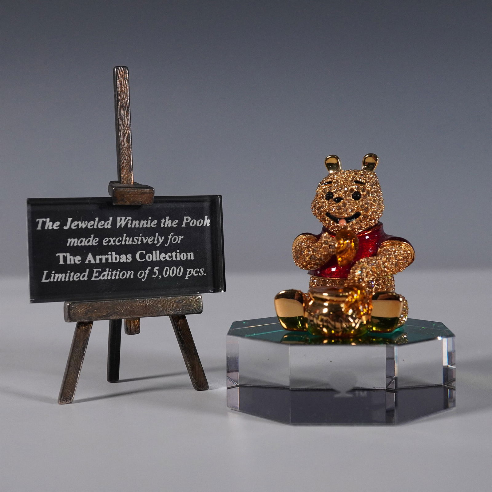 3pc Arribas Brothers Swarovski Winnie the Pooh with Base and Plaque: This exquisite jeweled figurine of Winnie the Pooh was exclusively crafted for the Arribas Collection with Swarovski crystals, renowned for its high-quality crystal artistry. This limited-edition coll