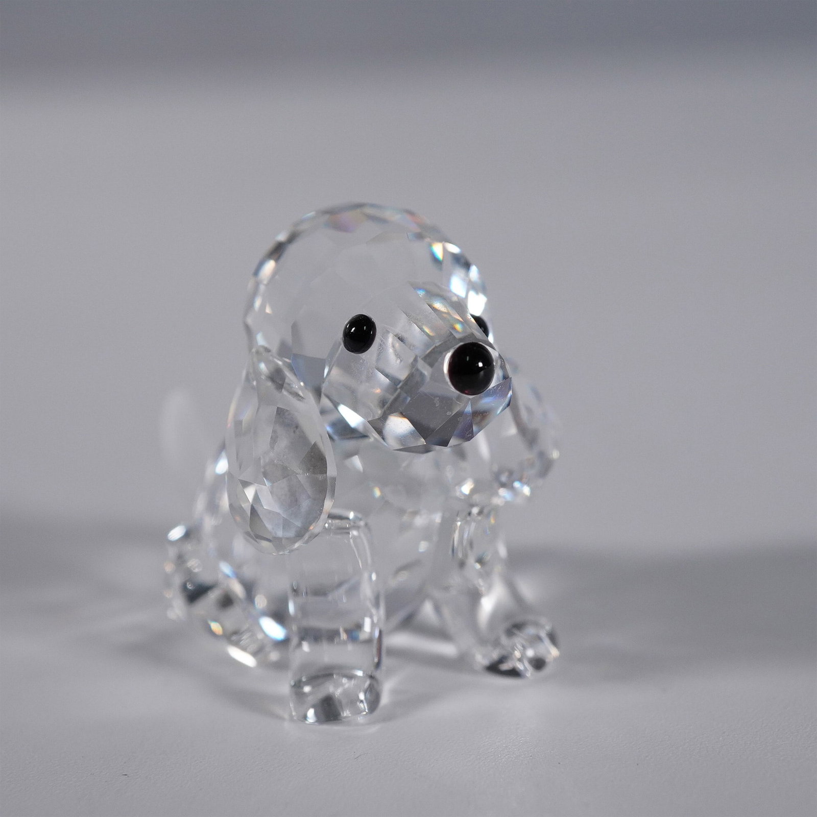 Swarovski Silver Crystal Beagle Figurine: This charming Swarovski Crystal Beagle Figurine captures the lovable essence of the beloved breed with precision-cut facets that sparkle beautifully. Featuring a detailed design with a faceted body, d