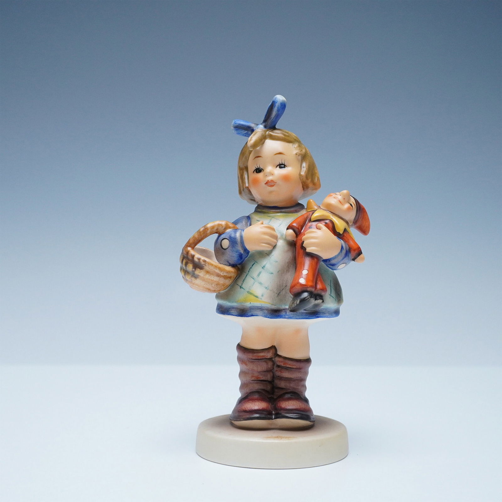 Goebel Hummel Special Edition Porcelain Figurine, What Now: Goebel Hummel figurine titled What Now, an exclusive Special Edition No. 7 created for members of the Goebel Collectors Club in 1981. This charming piece depicts a young girl clutching her doll and a