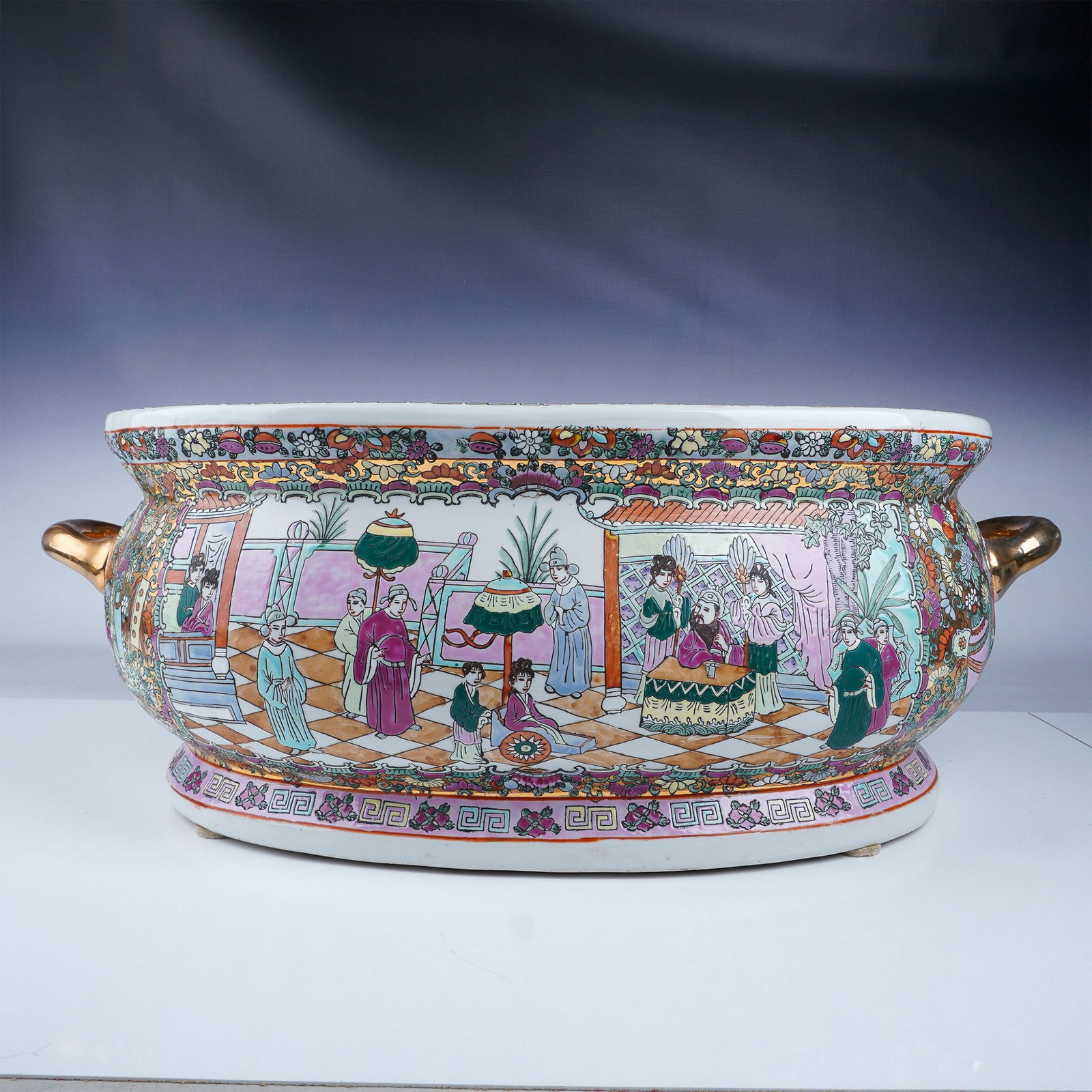 Chinese Rose Medallion Style Basin with Gold Handles: A large and ornate Chinese basin in the Rose Medallion style, featuring vibrant hand-painted scenes of courtly life, floral motifs, and intricate patterns. Accented with two gold-tone handles and deta