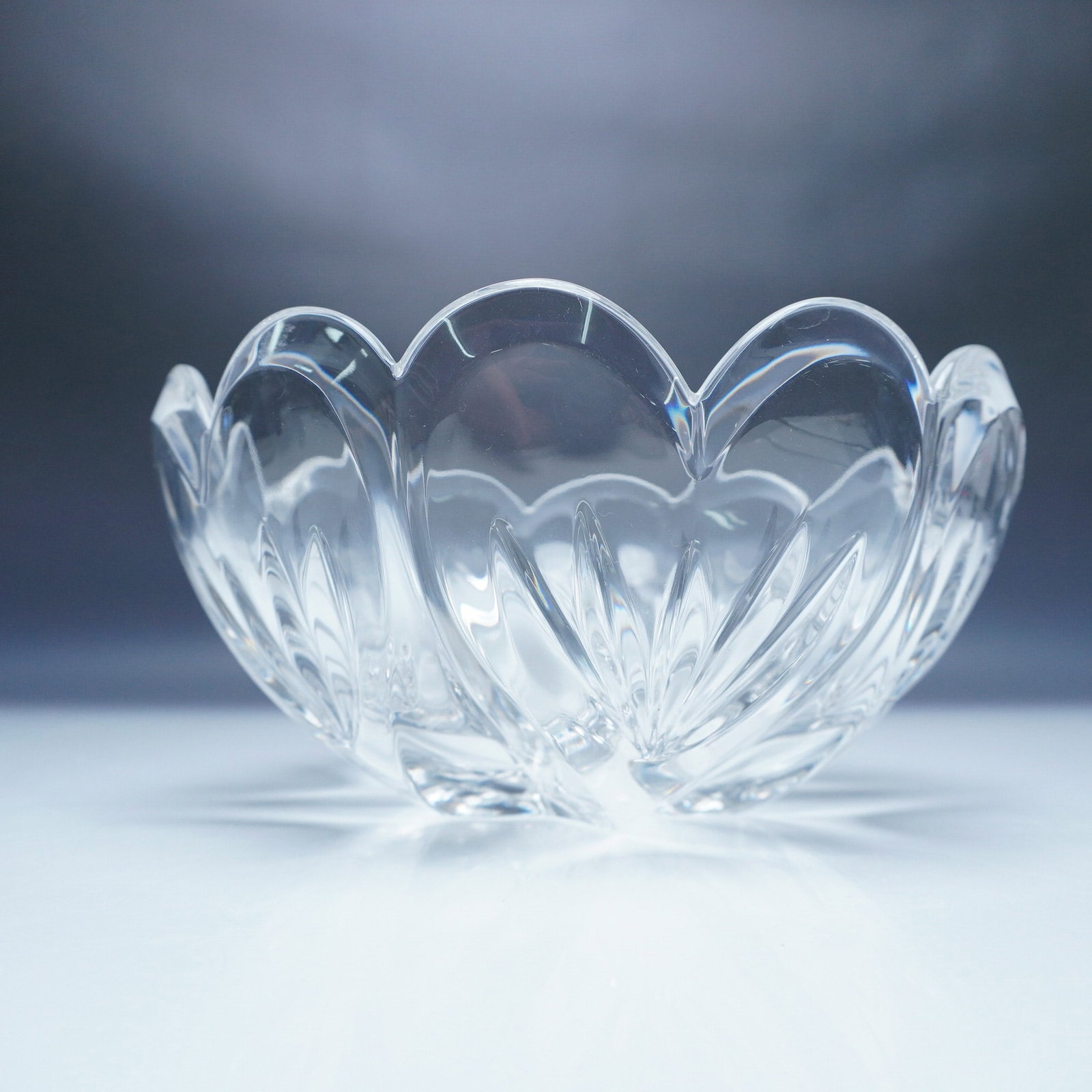 Marquis by Waterford Crystal Bowl, Fan Leaf: A beautifully crafted Marquis by Waterford crystal bowl featuring a scalloped rim and elegant fan and wedge cuts. This sophisticated design captures and refracts light beautifully, making it a stunnin