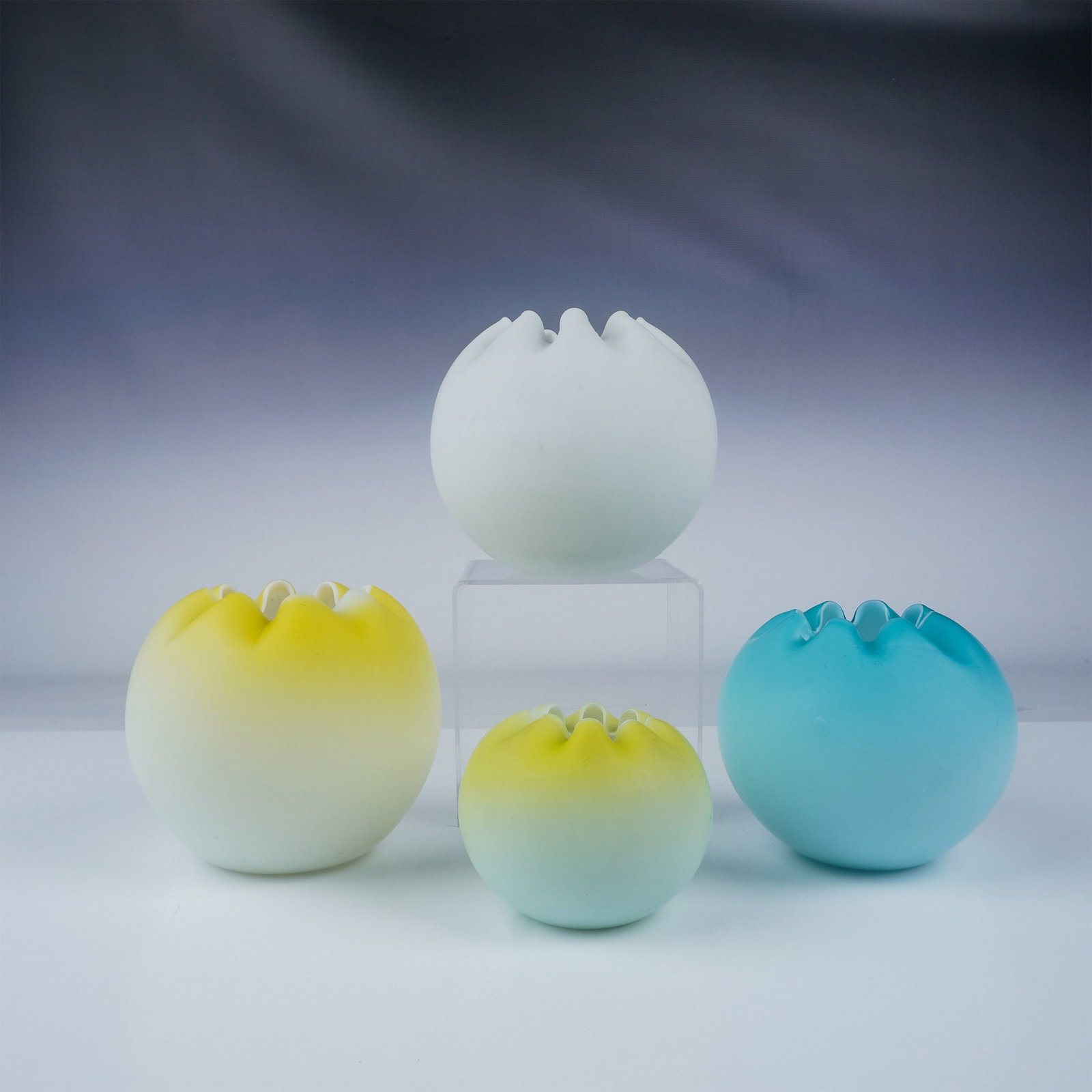 4pc Victorian Satin Glass Rose Bowls: A charming assortment of four Victorian satin glass rose bowls, each showcasing delicate craftsmanship and elegant design. The collection features various soft pastel hues, including yellow, blue, and