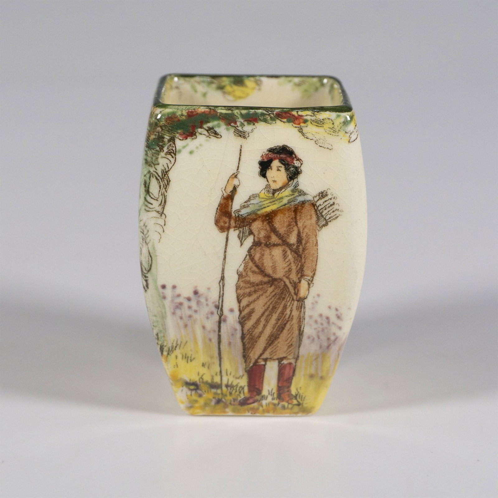 Royal Doulton Under the Greenwood Tree Vase, Maid Marian: A cream colored vase showing Maid Marian with a bow and quiver under a majestic tree. Royal Doulton backstamp. Marked Under the Greenwood Tree. Marked Maid Marian. Dimensions: 1.5"L x 1.5"W x 2.5"H Co