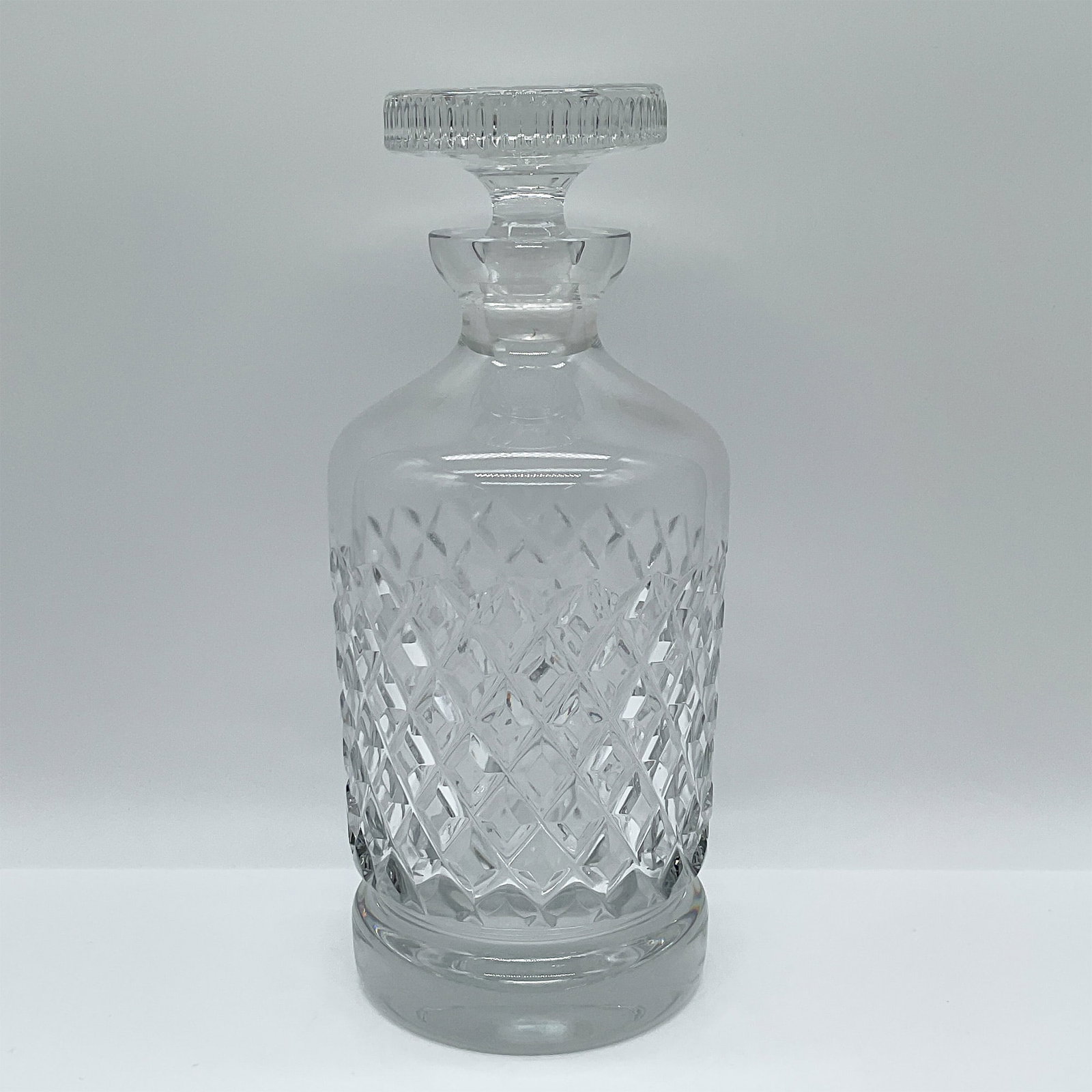 Cut Glass Decanter with Stopper: This elegant cut glass decanter features a timeless design with intricate diamond and crosshatch patterns, showcasing skilled craftsmanship. Complete with its original matching stopper, the decanter s