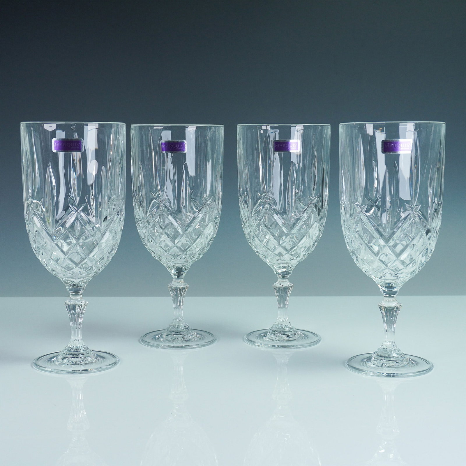 4pc Iced Beverage Glasses, Marquis by Waterford Markham: A set of four Marquis by Waterford iced beverage glasses in the Markham pattern, featuring the brand's signature cross-cut design and stunning clarity. Each glass stands 8.5"H, offering an elegant way