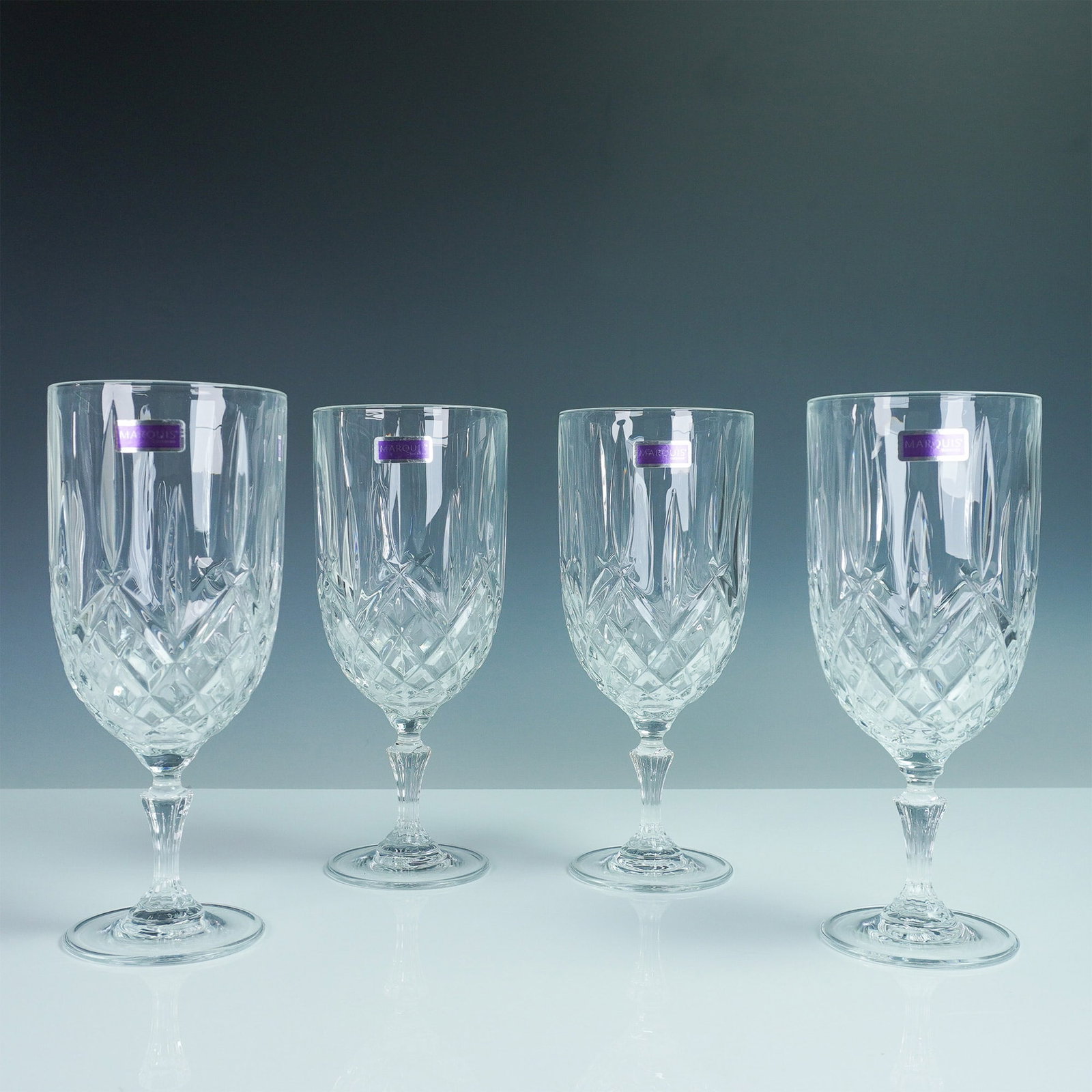 4pc Iced Beverage Glasses, Marquis by Waterford Markham: A set of four Marquis by Waterford iced beverage glasses in the Markham pattern, featuring the brand's signature cross-cut design and stunning clarity. Each glass stands 8.5"H, offering an elegant way