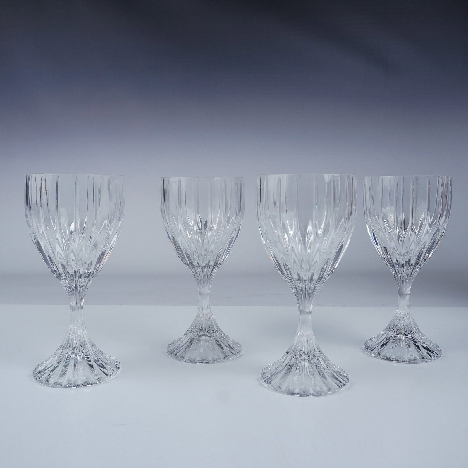 4pc Mikasa Crystal Wine Glasses, Park Lane: A set of four elegant clear crystal wine glasses by Mikasa in the timeless Park Lane pattern. Each glass features vertical cuts on the bowl and a ribbed stem, adding a sophisticated touch to any dinin