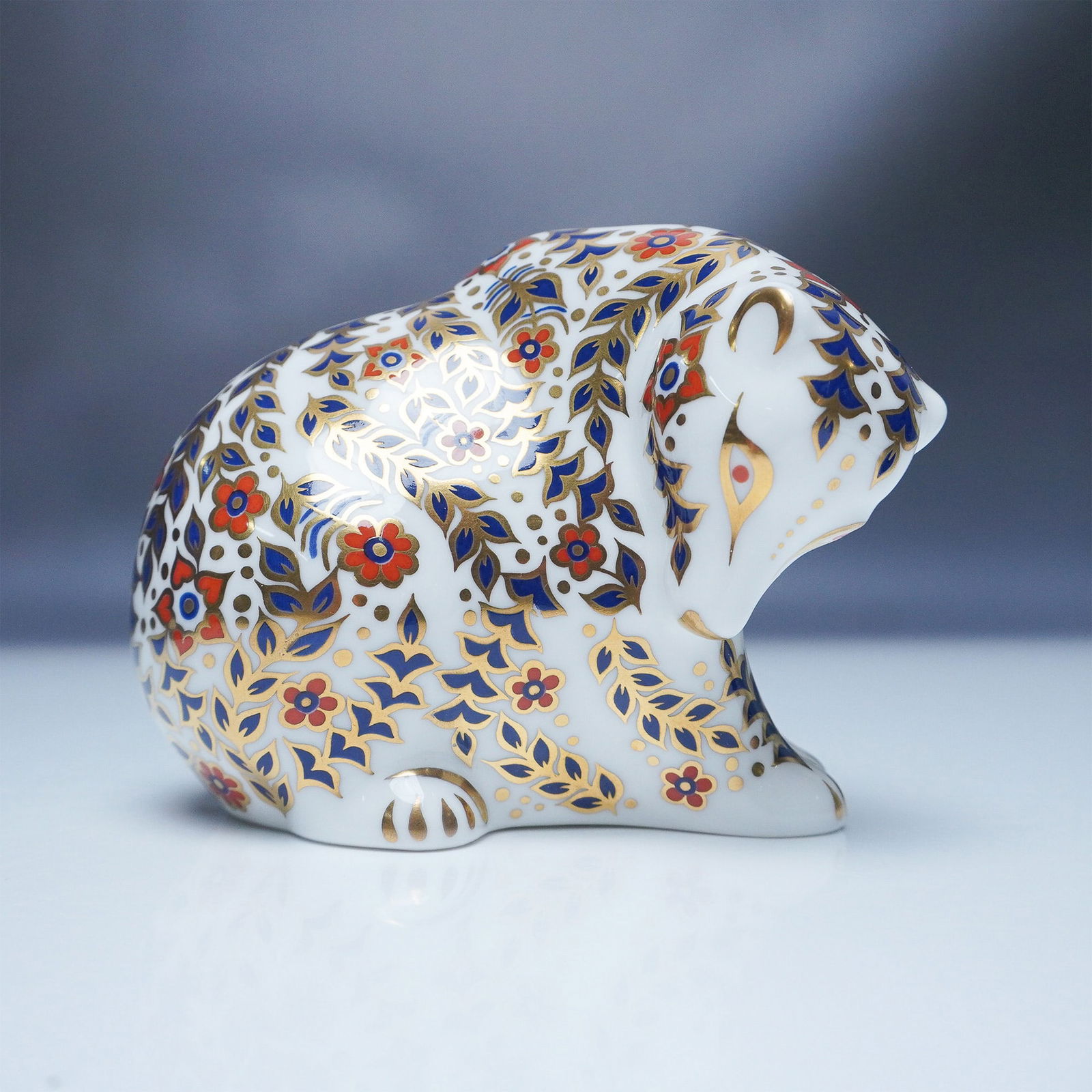 Royal Crown Derby Russian Bear Paperweight: Elegant Royal Crown Derby Russian Bear paperweight, crafted from fine bone china and featuring the brand's signature Imari pattern. The exquisite design showcases intricate floral and foliate motifs i