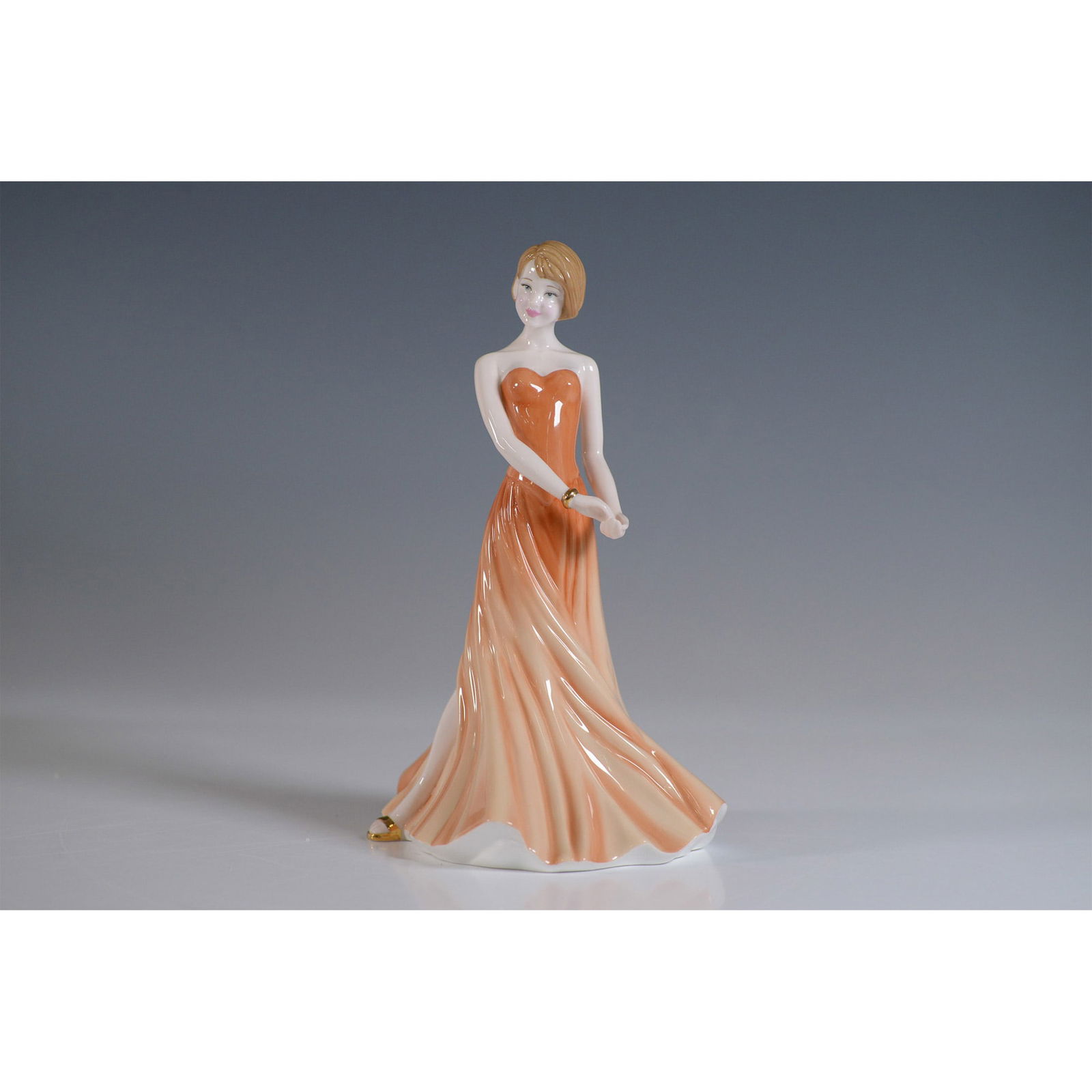 Chloe HN4727 with Box - Royal Doulton Figurine: This exquisite Royal Doulton figurine, titled Chloe (HN4727), is a part of the Pretty Ladies collection. Designed in England and released in 2004, this porcelain piece showcases a gracefully posed wom