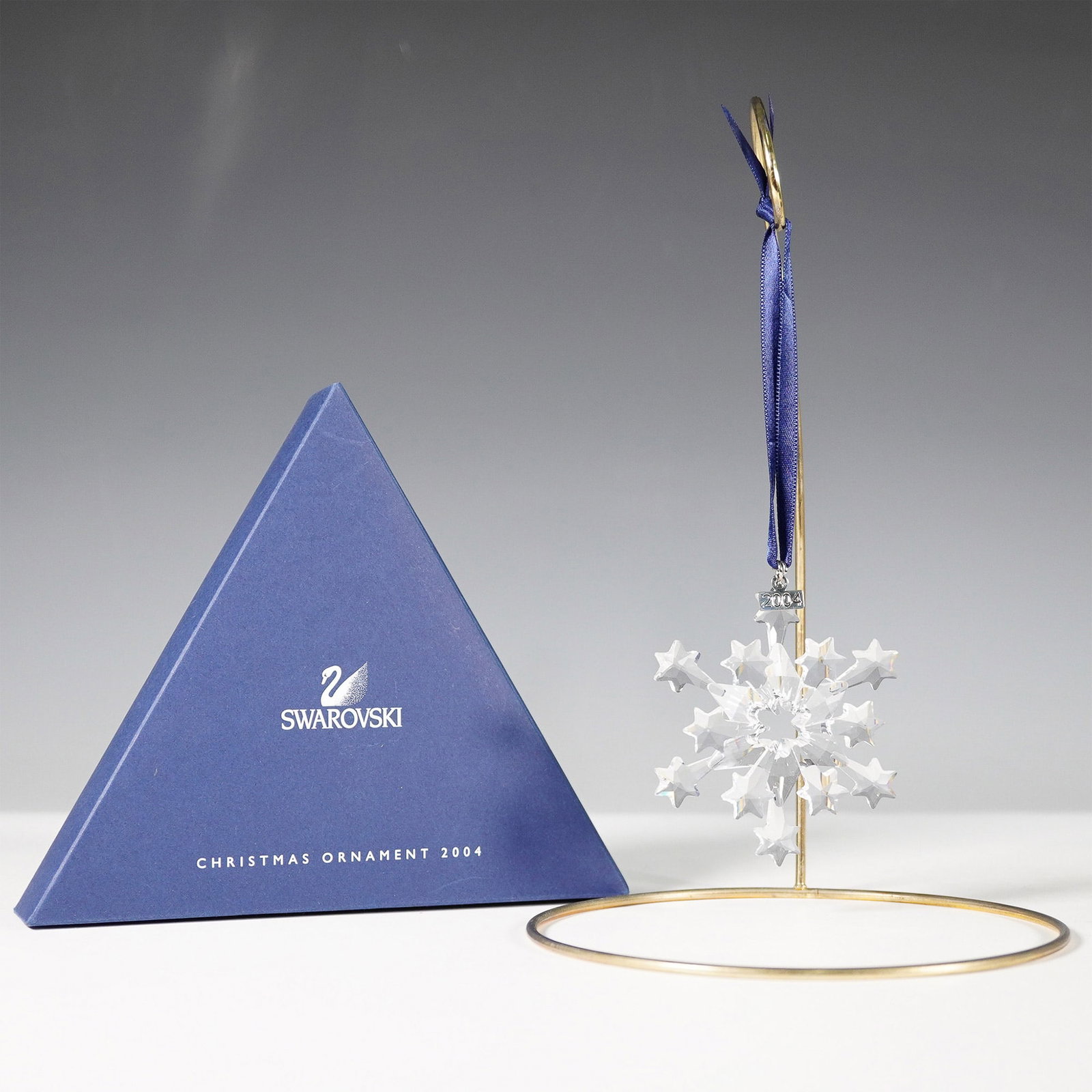 Swarovski 2004 Annual Christmas Ornament: Presenting the Swarovski 2004 Annual Christmas Ornament, a retired limited edition piece that exemplifies the brand's renowned craftsmanship. Designed by Edith Mair, this exquisite ornament features a