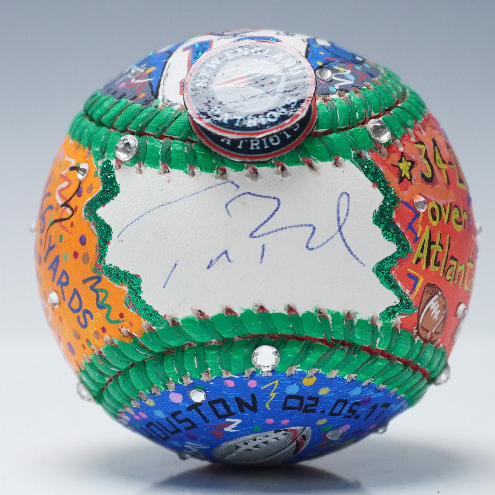 Tom Brady Signed Charles Fazzino Hand Painted Pop Art Baseball: Mixed media baseball featuring a hand-painted design by pop artist Charles Fazzino (American, b. 1955), commemorating Tom Brady's performance in Super Bowl LI. The artwork includes depictions of key g