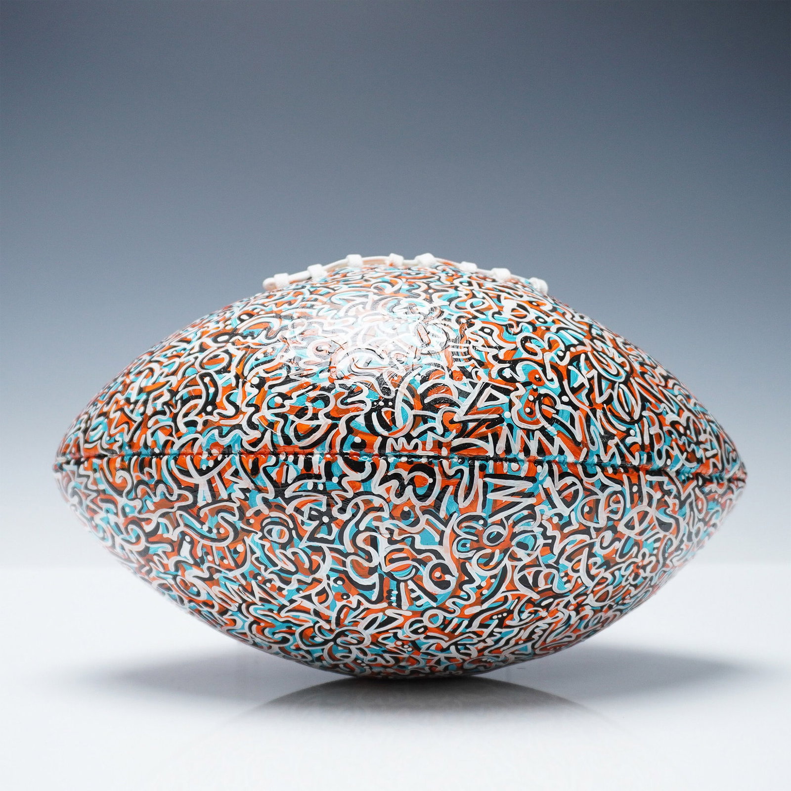 Abraham Onkst Hand-Painted Art Football: A unique, hand-painted full-size football featuring the signature abstract graffiti-style artwork of Abraham Onkst, known for his intricate and vibrant designs. This football showcases a striking patt