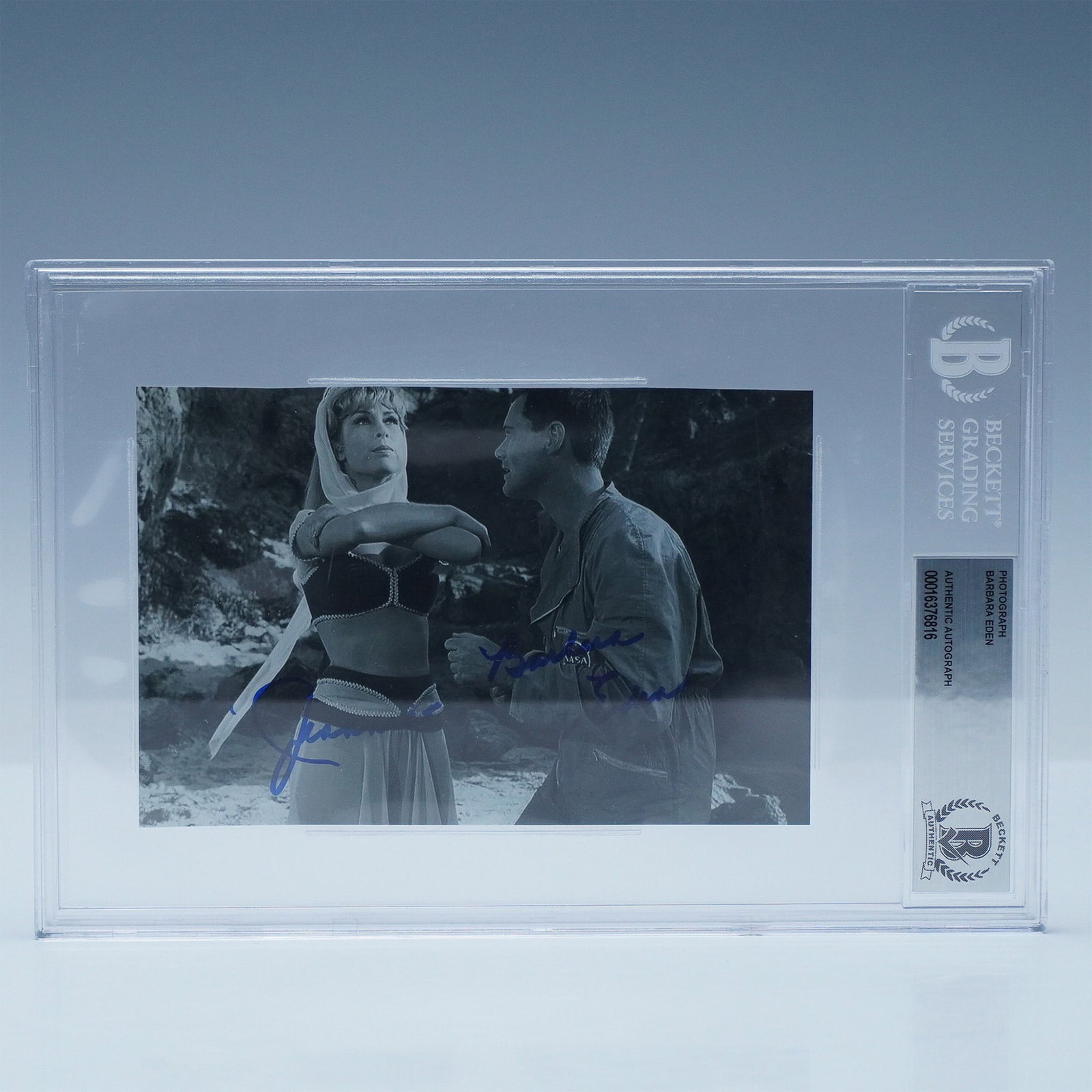 Barbara Eden & "Jeannie" Signed I Dream of Jeannie Photograph: A black-and-white promotional photograph from the beloved television series I Dream of Jeannie, featuring Barbara Eden as Jeannie and Larry Hagman as Major Tony Nelson. This unique piece is signed by