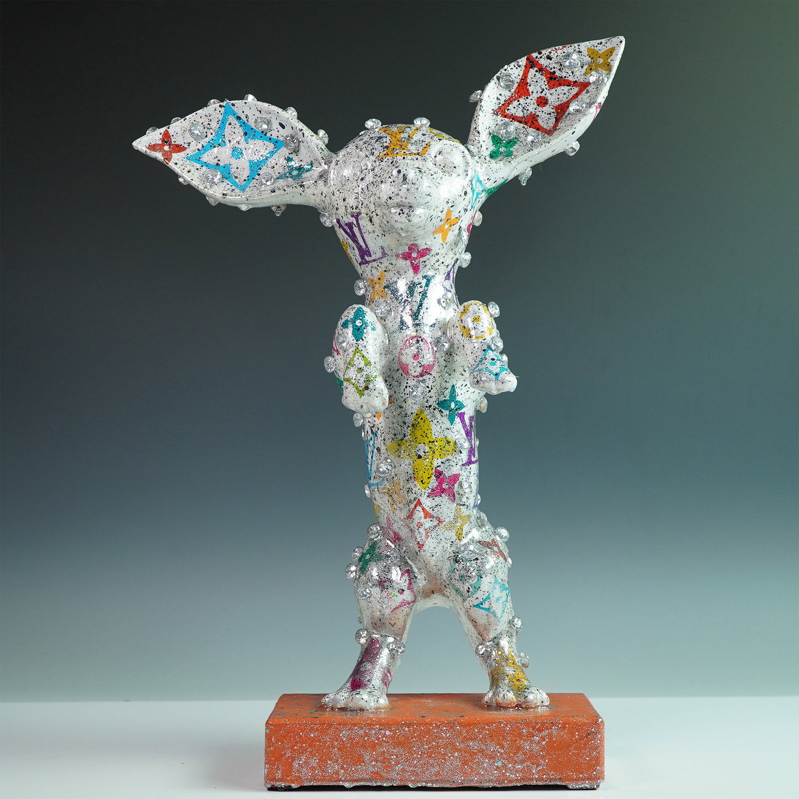 Khalil Douisse LV Chihuahua Dog Sculpture with Certificate of Authenticity: A striking mixed-media Chihuahua dog sculpture by Khalil Douisse, featuring a dazzling silver finish with multicolored Louis Vuitton-inspired motifs. This contemporary artwork is embellished with spar