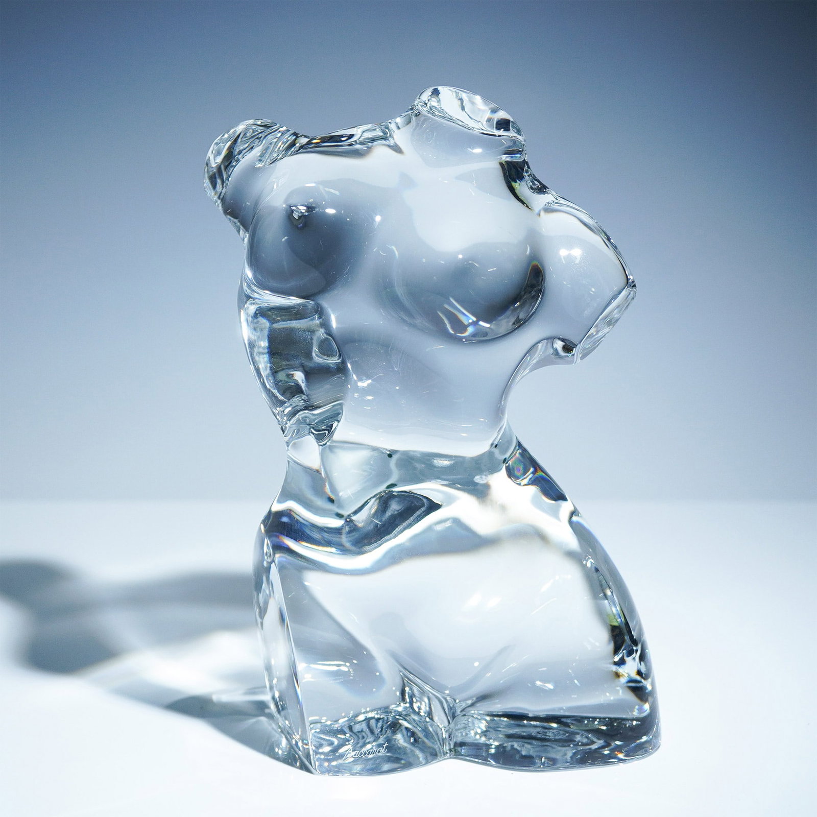 Baccarat Crystal Female Torso Sculpture: Elegant clear crystal female torso sculpture by Baccarat, capturing the timeless beauty of the human form in a stylized and curvaceous silhouette. This substantial piece is signed with the Baccarat sc