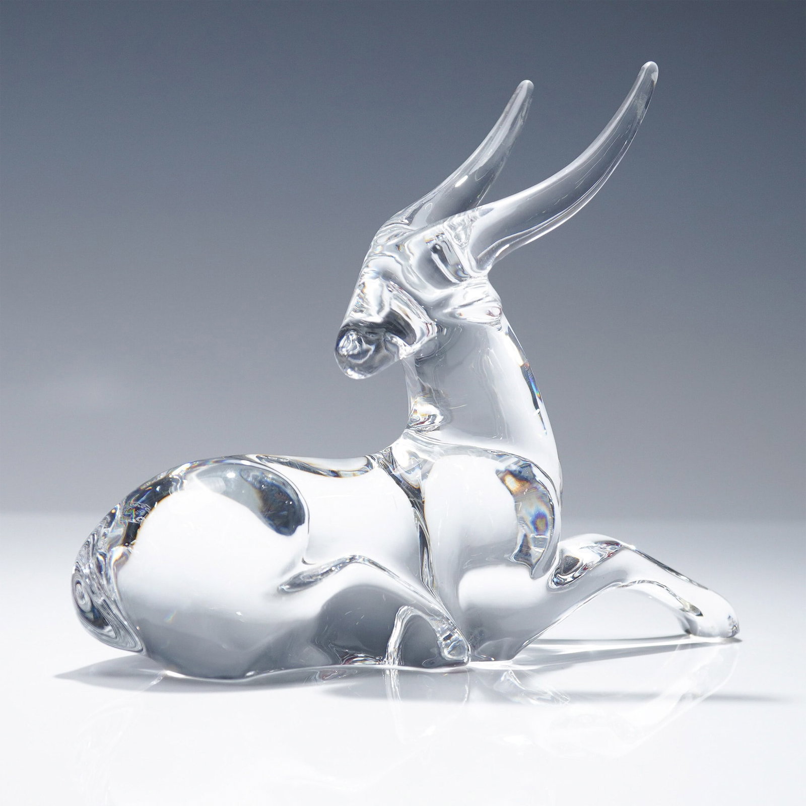 Baccarat Crystal Antelope Figurine: Clear crystal antelope figurine by Baccarat, featuring elegant curves and sleek detail. Marked with the etched Baccarat signature and artist name Loet. Presented with the original red Baccarat box, th