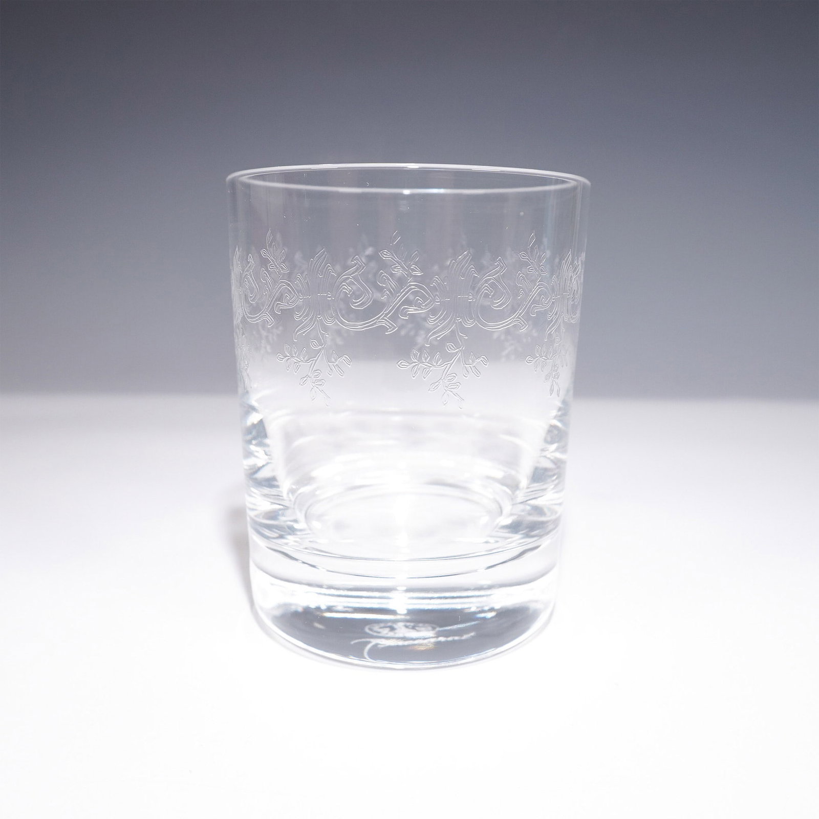 Baccarat Crystal Old Fashioned Drinkware, Sevigne: Crafted of clear crystal, the glass features an etched design with repeating scrolls and leaf motifs encircling the upper section of the bowl. The base bears the Baccarat acid-etched mark. Includes th