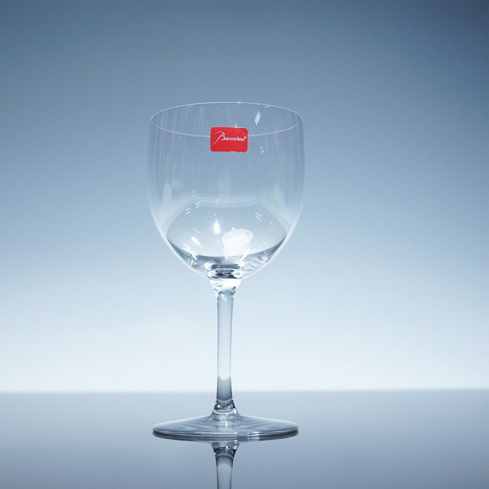 Baccarat Crystal Claret Wine Glass, Brummel, with Box: A refined Baccarat crystal claret wine glass from the distinguished Brummel collection, presented with its original signature red box. Featuring sleek curves and a weighted base, this glass showcases 