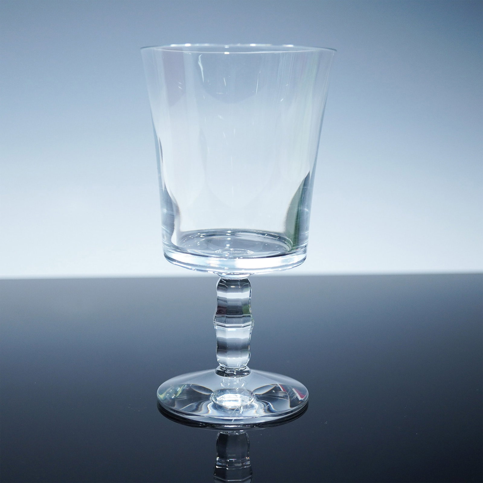 Baccarat Crystal Wine Goblet, Faceted Stem, with Box: Elegant Baccarat crystal wine goblet featuring a smooth, clear bowl, a faceted stem, and a classic hexagonal base. Expertly crafted in France, this goblet showcases the timeless craftsmanship for whic