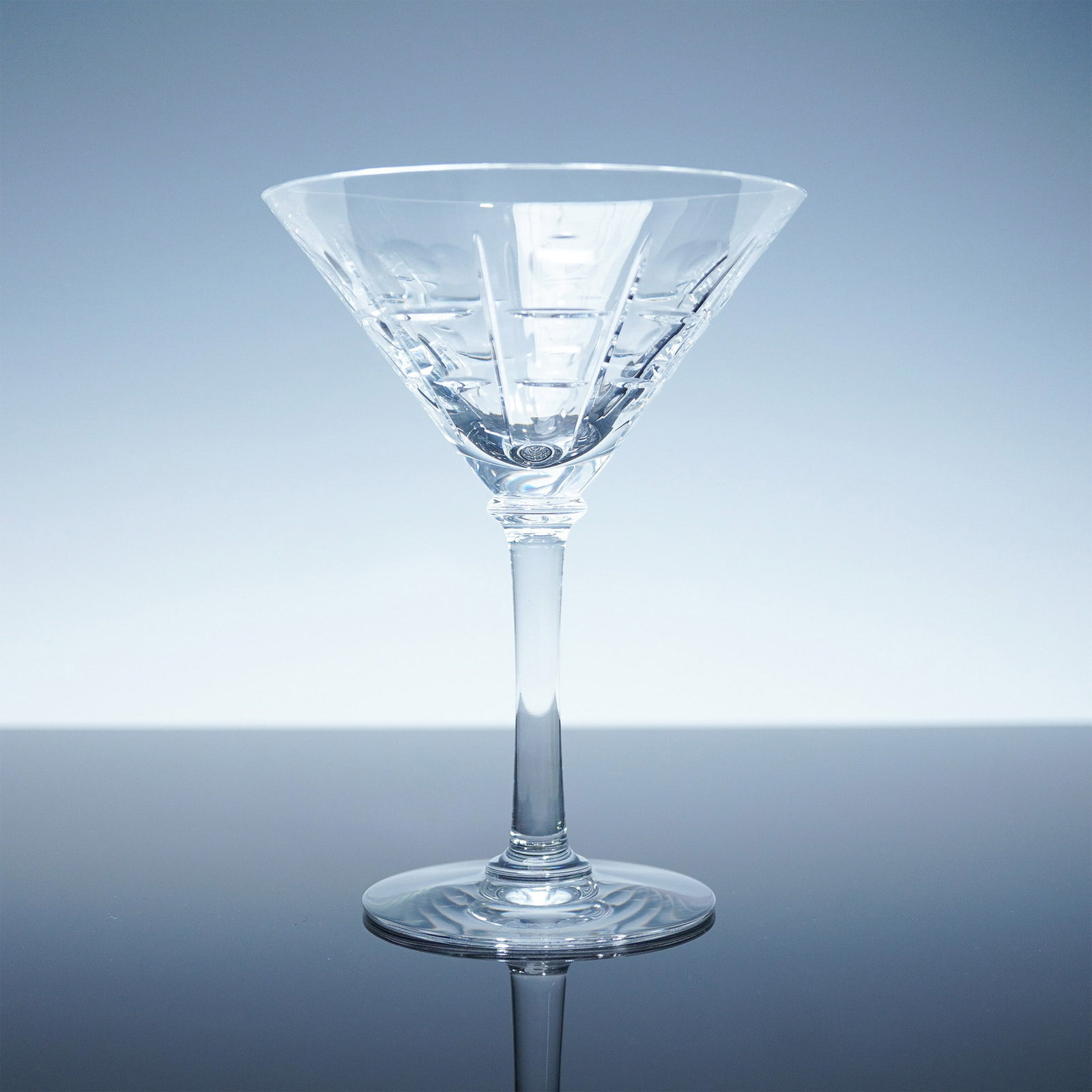 Baccarat Crystal Martini Glass, Equinox Pattern, Boxed: Refined and sophisticated, this Baccarat crystal martini glass is from the sought-after Equinox Collection. With its sleek silhouette and modern vertical cuts, this piece exemplifies Baccarat?s legacy