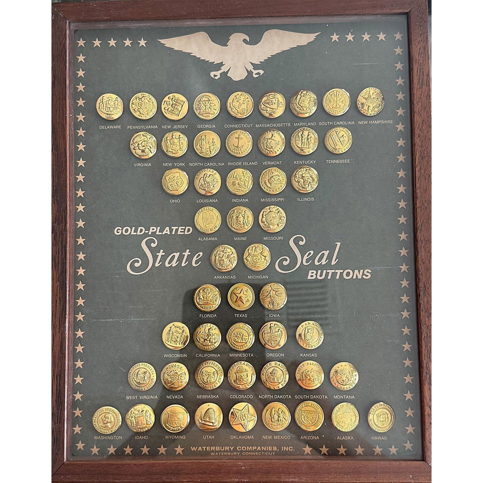 A full tray of brass State Seal buttons