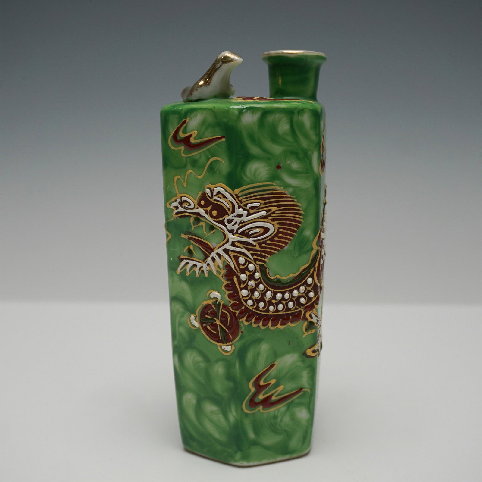 Occupy Japan Moriage Dragonware Porcelain Sake Bottle: Vintage Japanese Moriage Dragonware porcelain sake bottle, marked Made in Occupied Japan on the underside. This hexagonal bottle features an intricate hand-applied moriage dragon design in raised reli