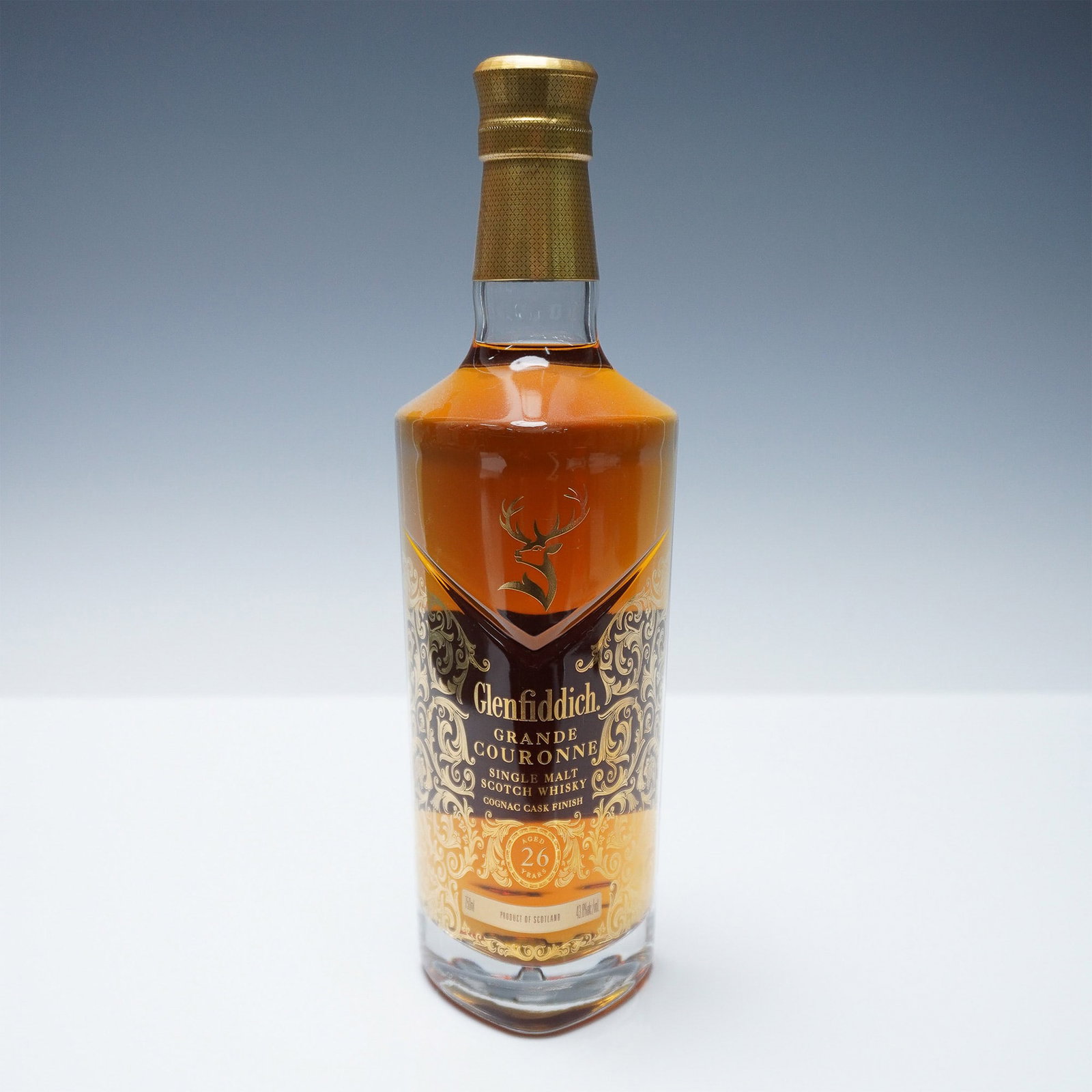 Glenfiddich Grande Couronne 26-Year-Old Single Malt Scotch Whisky: A bottle of Glenfiddich Grande Couronne, an exceptional 26-year-old single malt Scotch whisky finished in rare French Cognac casks. This luxurious expression from Glenfiddich's renowned distillery off