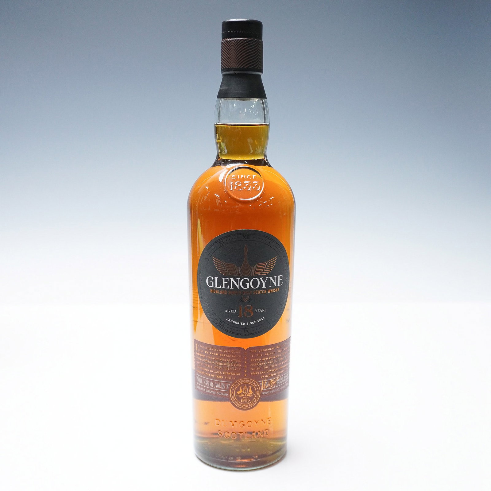 Glengoyne 18-Year-Old Highland Single Malt Scotch Whisky: A distinguished bottle of Glengoyne 18-Year-Old Highland Single Malt Scotch Whisky. Crafted at the Glengoyne Distillery in Scotland, this whisky undergoes a meticulous aging process in sherry-seasoned