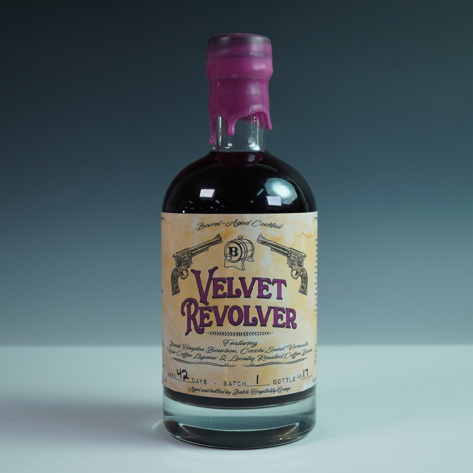 Velvet Revolver Barrel-Aged Cocktail by Batch Hospitality Group: A handcrafted, small-batch barrel-aged cocktail, the Velvet Revolver is a unique blend featuring Basil Hayden Bourbon, Cocchi Sweet Vermouth, Nola Coffee Liqueur, and locally roasted coffee beans. Age