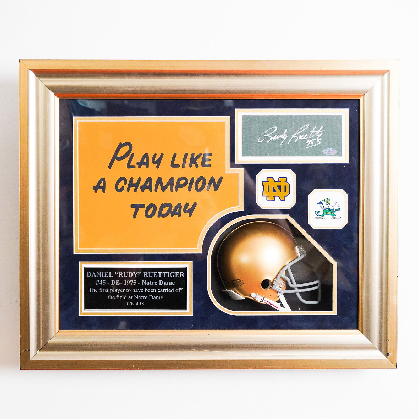 Rudy Ruettiger Signed Notre Dame Shadow Box Display, Steiner Authenticated: This Notre Dame Fighting Irish shadow box display celebrates the inspiring story of Rudy Ruettiger, the legendary walk-on player immortalized in the 1993 film Rudy. The display features Ruettiger's ha