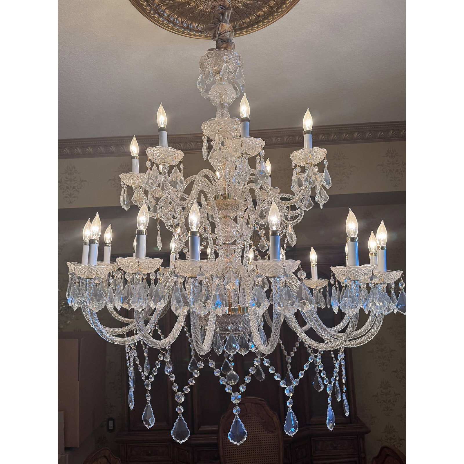Chambord 24-Light Crystal Chandelier, Handcrafted Glass: A magnificent Chambord 24-light crystal chandelier, exquisitely designed with handblown twisted glass arms, faceted crystal bobeches, and cascading crystal prisms. This luxurious lighting fixture embo