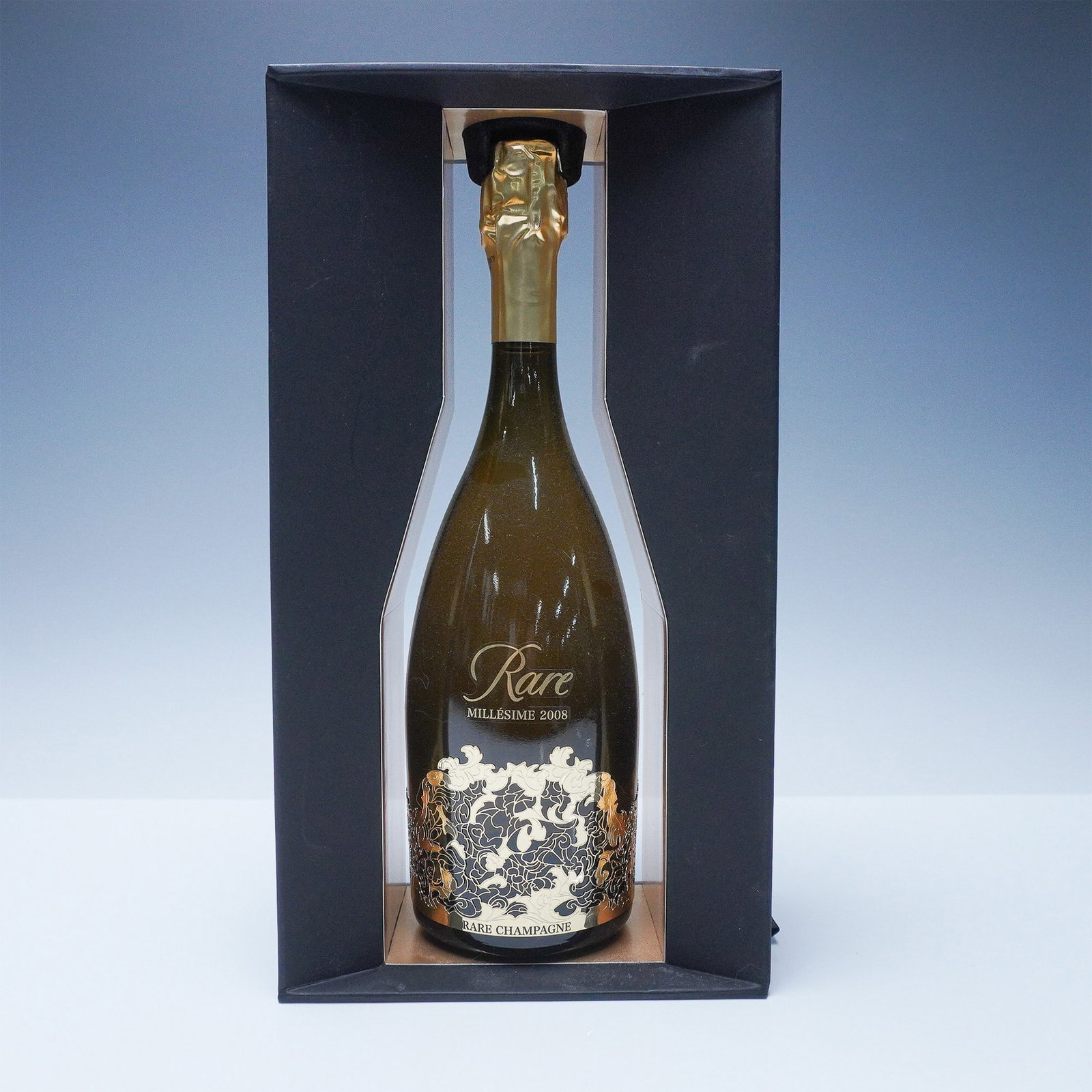 Rare Champagne Millesime 2008 in Presentation Box: This lot features a Rare Champagne Millesime 2008 bottle, elegantly presented in its original open-front black presentation box. Rare Champagne is renowned for its exceptional quality and limited prod