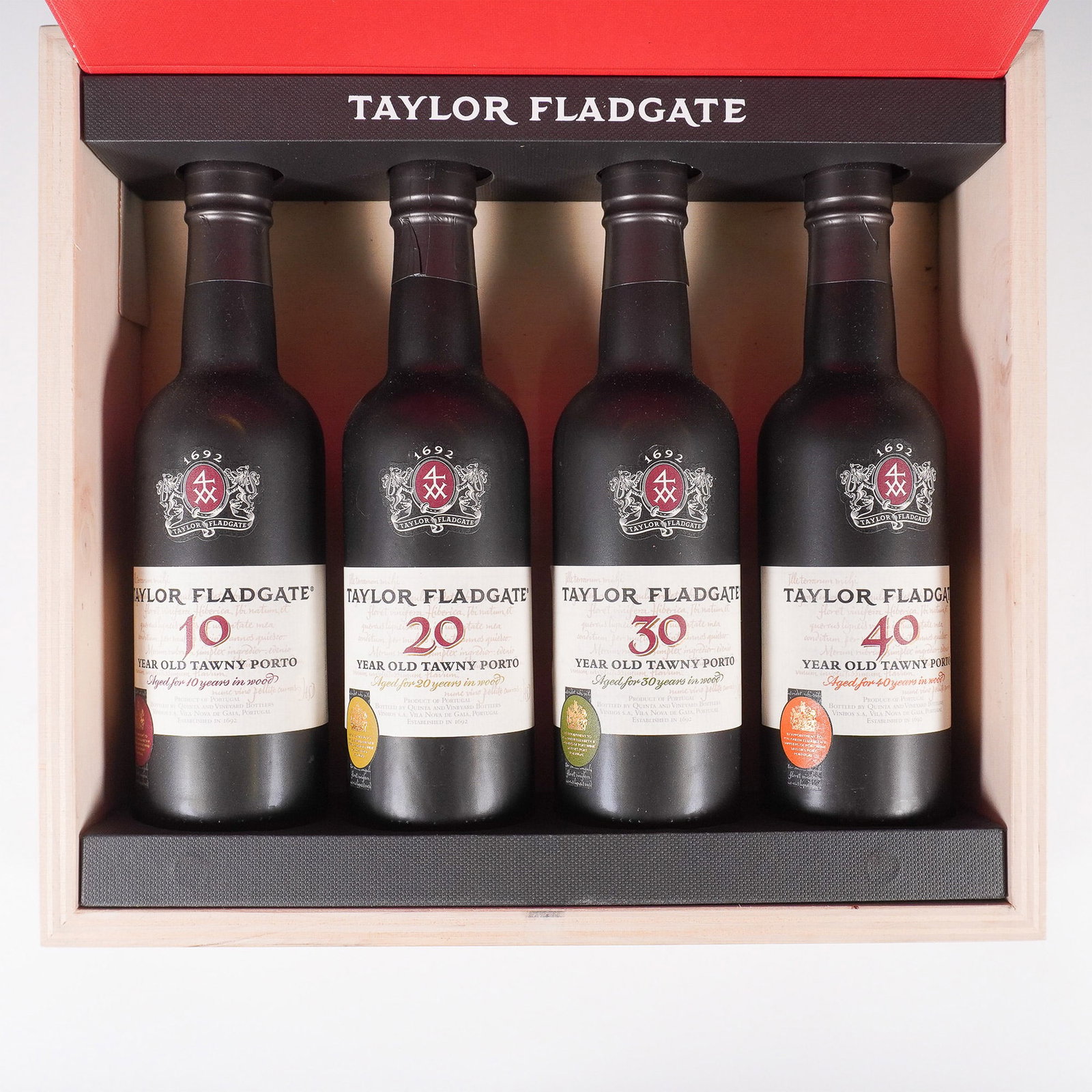 Taylor Fladgate Tawny Port Vertical Tasting Set in Wooden Presentation Box: A luxurious Taylor Fladgate Tawny Port vertical tasting set featuring four bottles of aged tawny port: 10, 20, 30, and 40-year-old expressions. Taylor Fladgate, one of the oldest and most esteemed Por