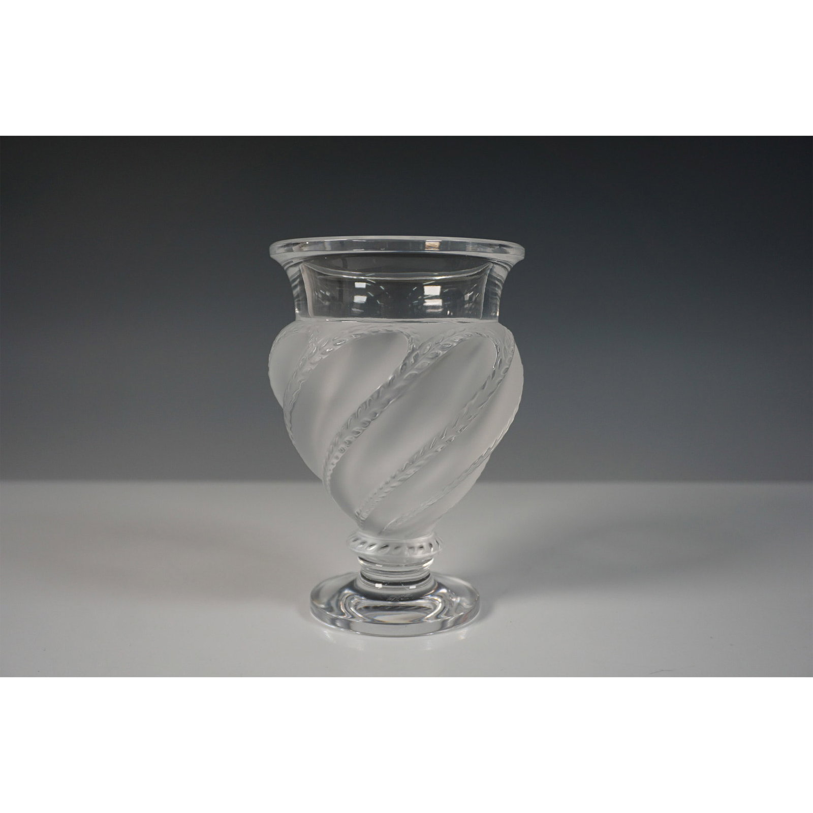Lalique Crystal Ermenonville Vase: A Lalique crystal vase in the Ermenonville design, showcasing a frosted bulbous form adorned with elegant swirling leafy vines. This sophisticated piece exemplifies Lalique's mastery in blending satin