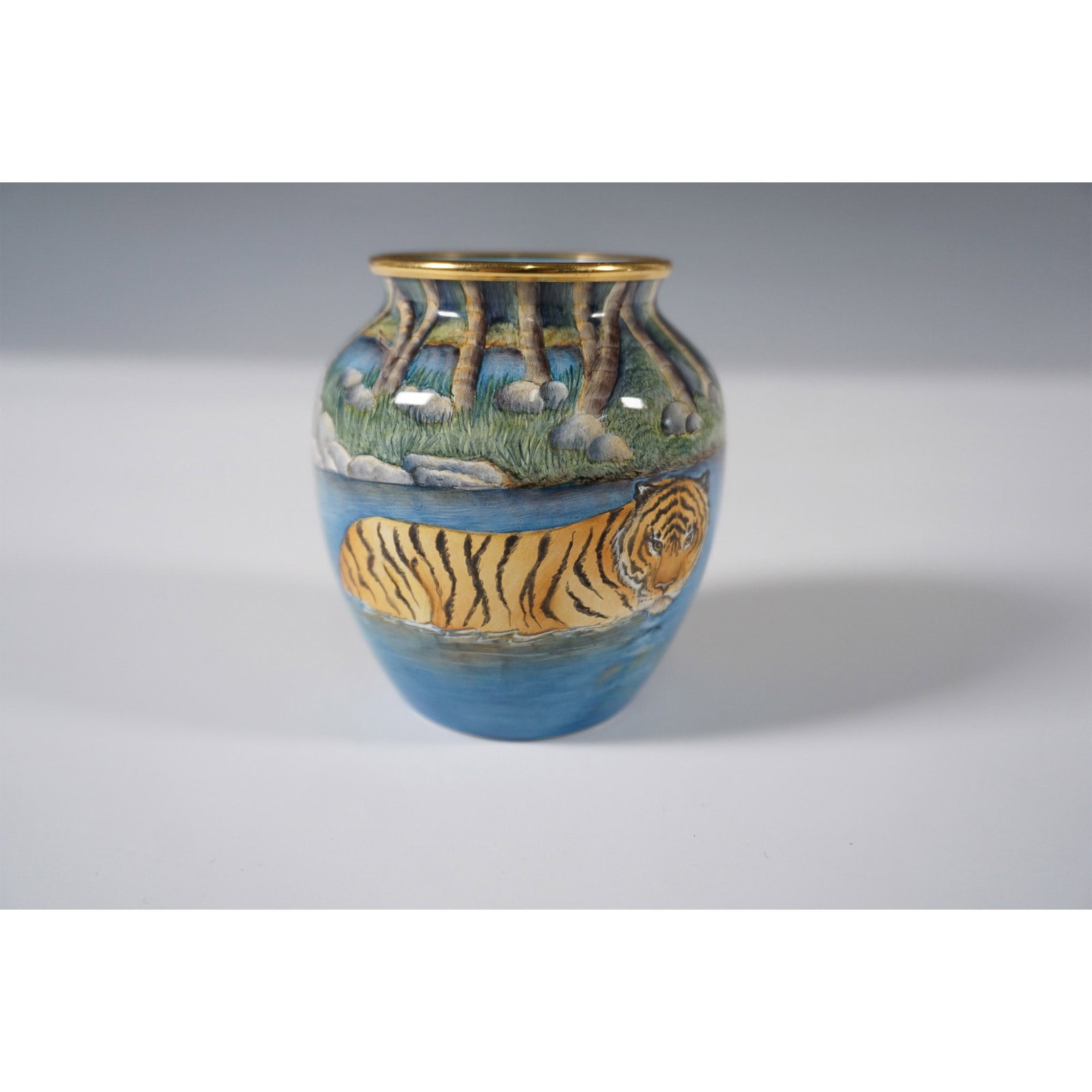 Moorcroft Enamel by Sandra Dance Tiger Vase: A crafted Moorcroft enamel vase featuring an intricately hand-painted wildlife scene by artist Sandra Dance. This limited edition piece showcases a striking depiction of tigers wading through a river,