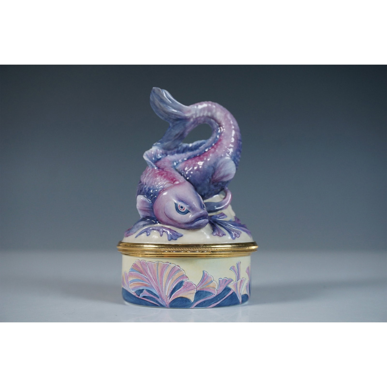Moorcroft and Bronte by J. Bishop Box, Hesperian Carp: This limited edition Moorcroft and Bronte bone china box, designed by J. Bishop, showcases masterful craftsmanship and intricate artistry. The piece features a sculpted finial in the form of a gracefu