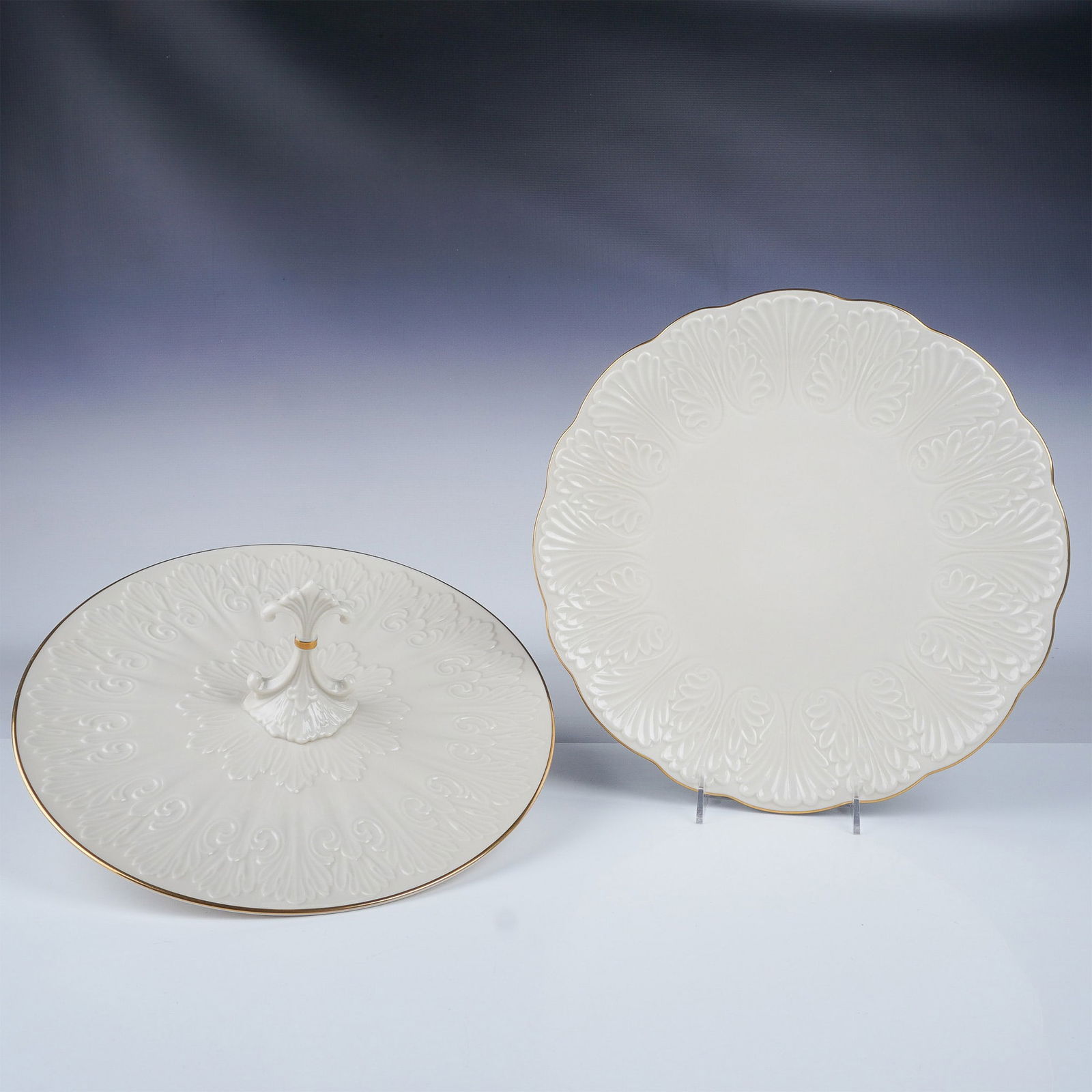2pc Lenox Embossed Ivory Porcelain Serving Plates with Gilt : Elegant Lenox embossed ivory porcelain serving plates featuring intricate raised patterns and gilt trim. This lot includes a round handled serving tray (13" dia.) and a scalloped-edge plate (12.5" dia