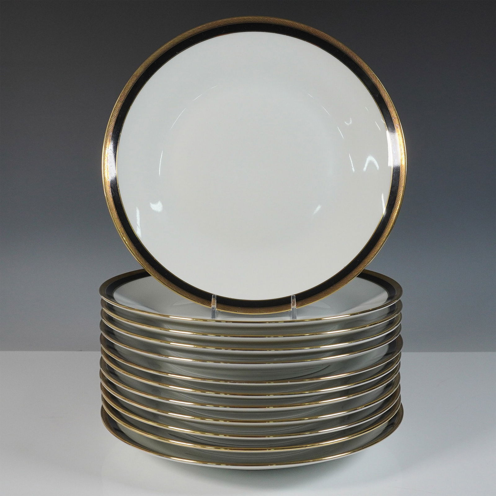 12pc Richard Ginori Palermo Black Fine China Dinner Plates : Elegant fine china dinner plates by Richard Ginori, a renowned Italian porcelain manufacturer. Each plate showcases a refined white porcelain body adorned with a striking black band and an intricate g