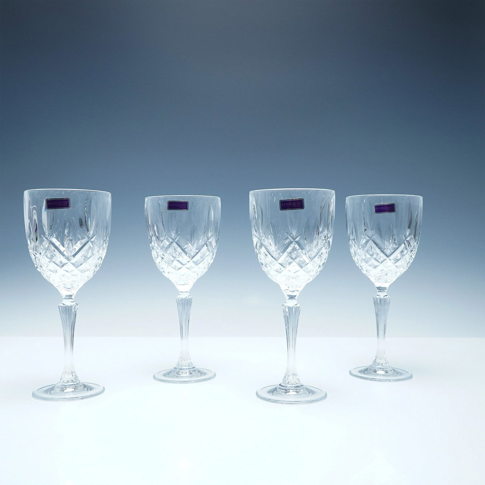 4pc Wine Goblets Marquis by Waterford Markham : A set of four Marquis by Waterford wine goblets in the Markham pattern, known for its elegant cross-cut design and brilliant clarity. Each goblet stands 8.75"H, making them ideal for serving wine in a