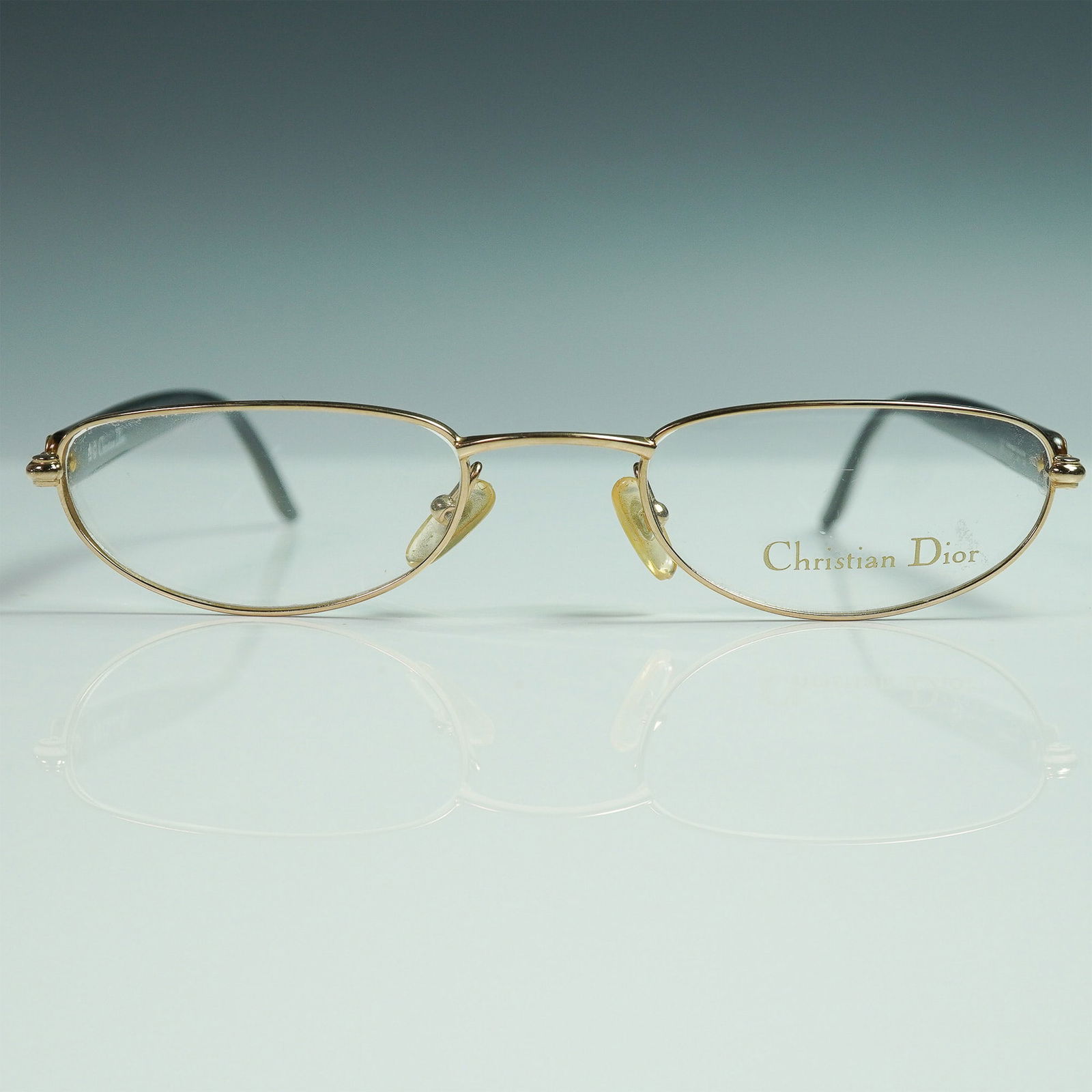 Christian Dior Eyeglasses with Gold Metal Frame: refined pair of Christian Dior eyeglass frames, model CD 3511. These vintage designer frames feature a gold-tone metal front with signature engraved clear lenses, paired with sleek black and brown arm